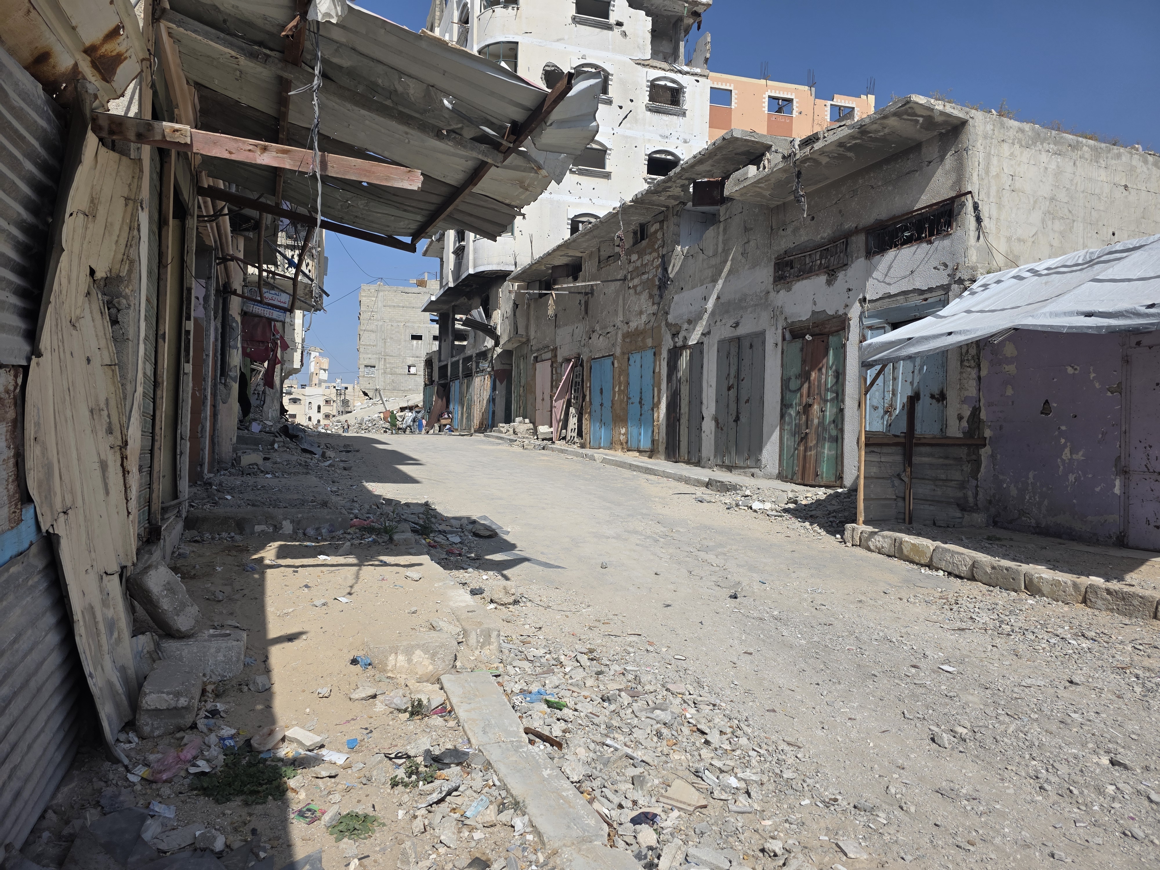 Rows of damaged and closed shops in the market