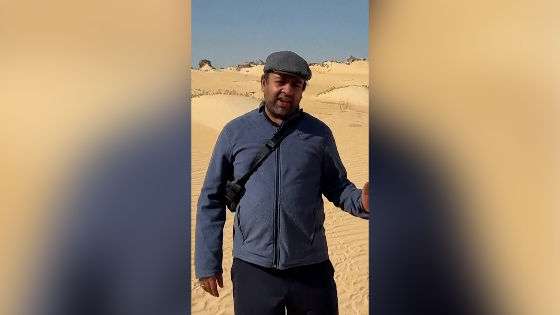 Varun Krishnan stands alongside the road connecting Qatar and Saudi Arabia. [Varun Krishnan via AP]