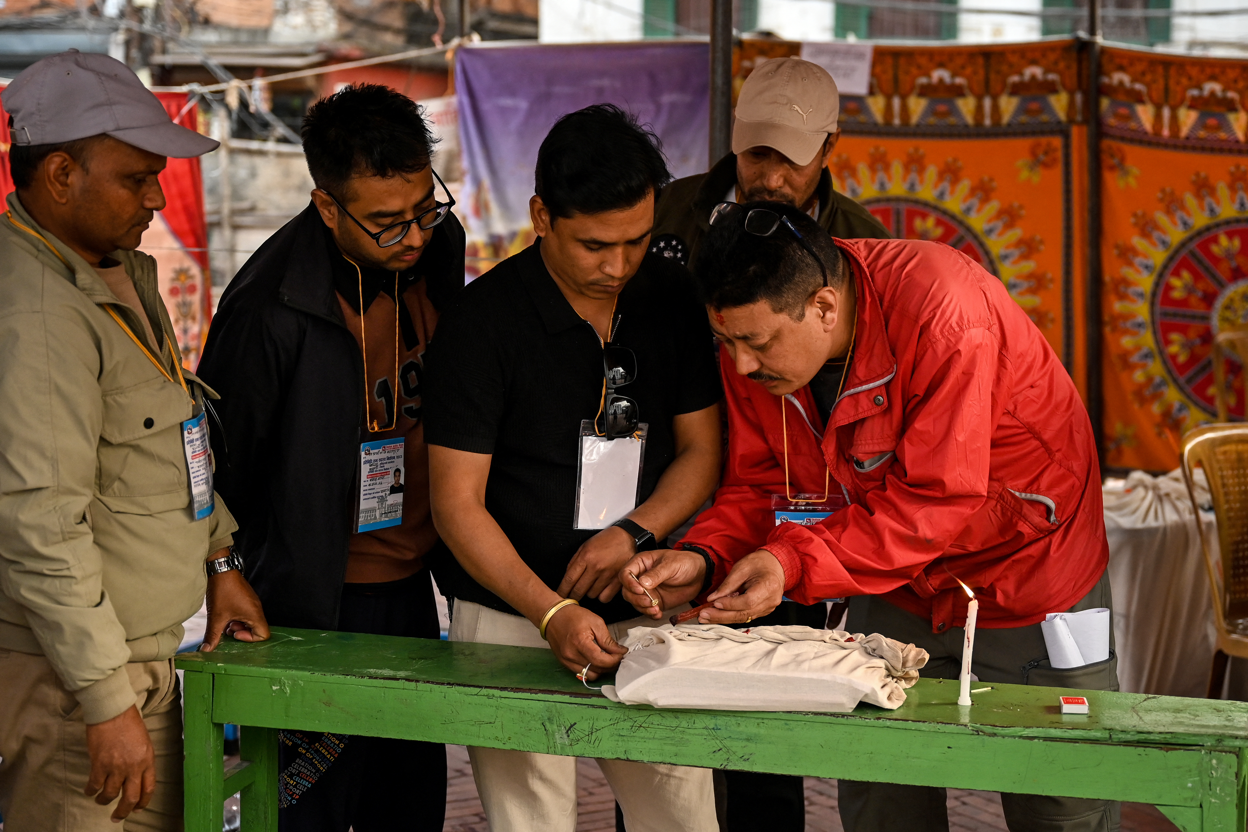 Electoral officials seal polling material after voting ends at a polling station during Nepal's general election in Kathmandu on March 5, 2026.