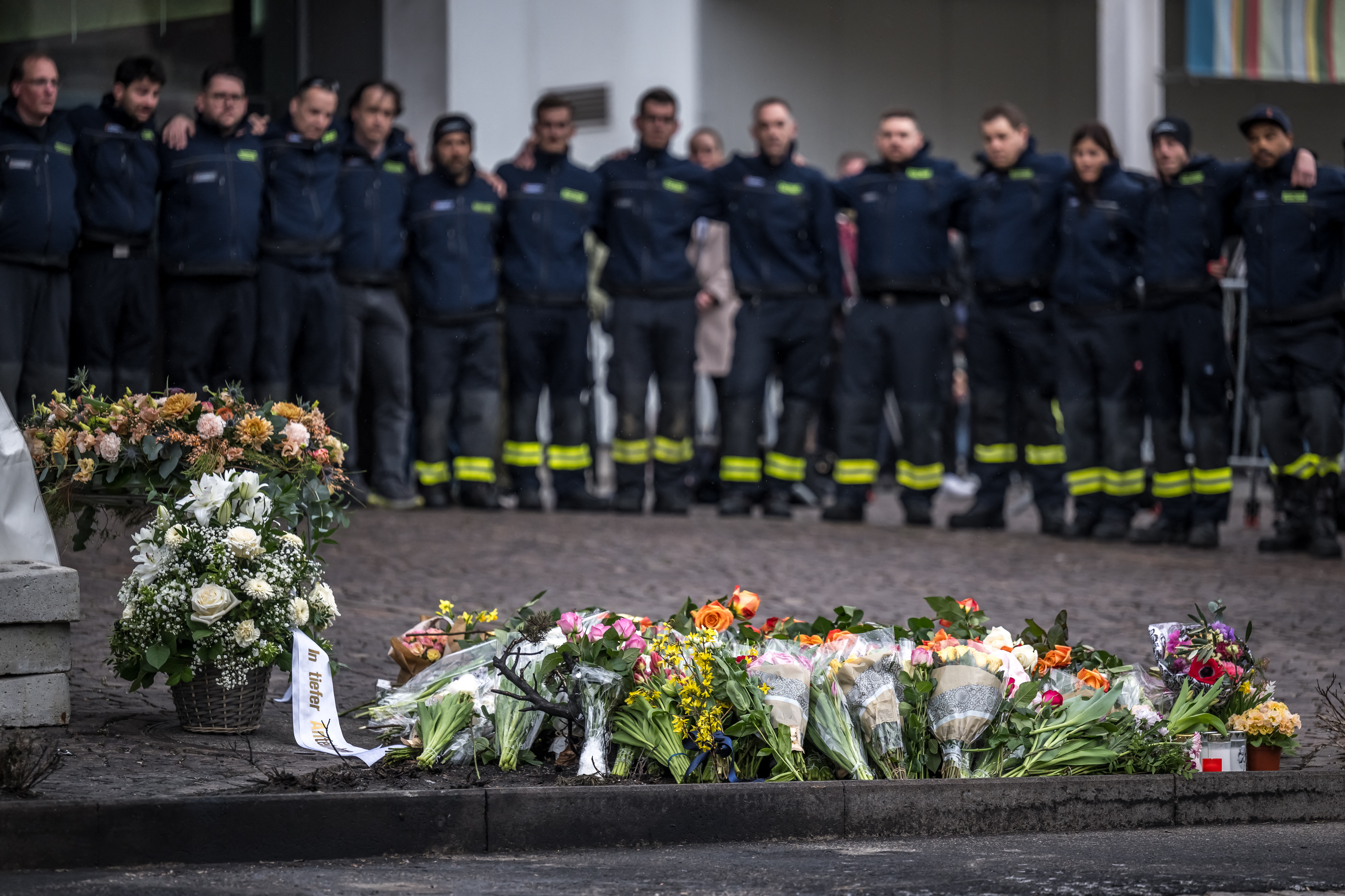 Firefighters attend a memorial ceremony in Kerzers, western Switzerland on March 11, 2026, the day after six people were killed in a bus fire which was seemingly started by a disturbed man on board who set himself alight.