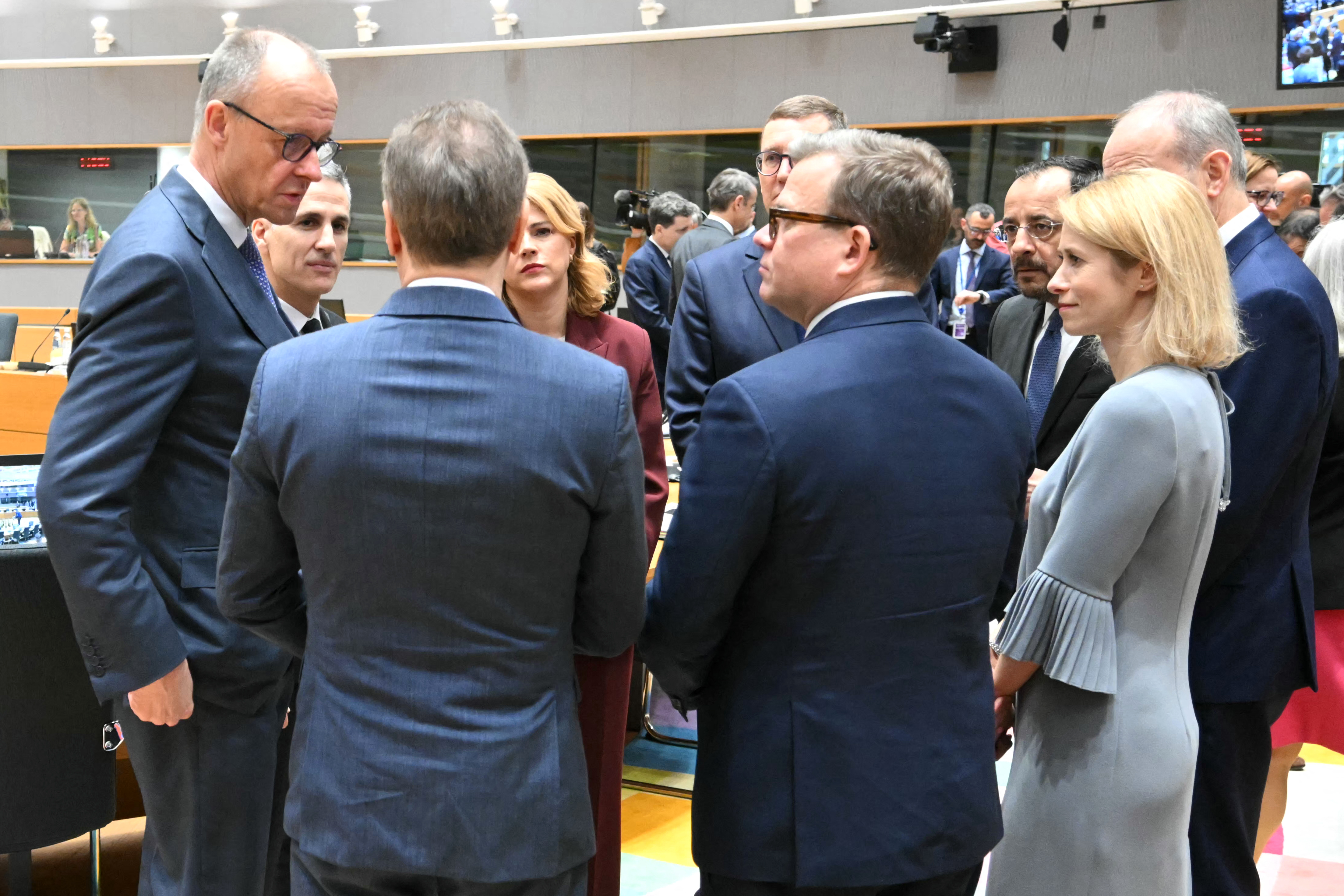 Germany's Chancellor Friedrich Merz (L) speaks with (from L) Bulgaria Caretaker Prime Minister Andrey Gurov, Latvia's Prime Minister Evika Silina, Estonia's Prime Minister Kristen Michal, Finland's Prime Minister Petteri Orpo, Cyprus' President Nikos Christodoulides and EU High Representative and Vice-President for Foreign Affairs and Security Policy Kaja Kallas ahead of rountable during the EU Summit at the EU headquarters in Brussels, on March 19, 2026.