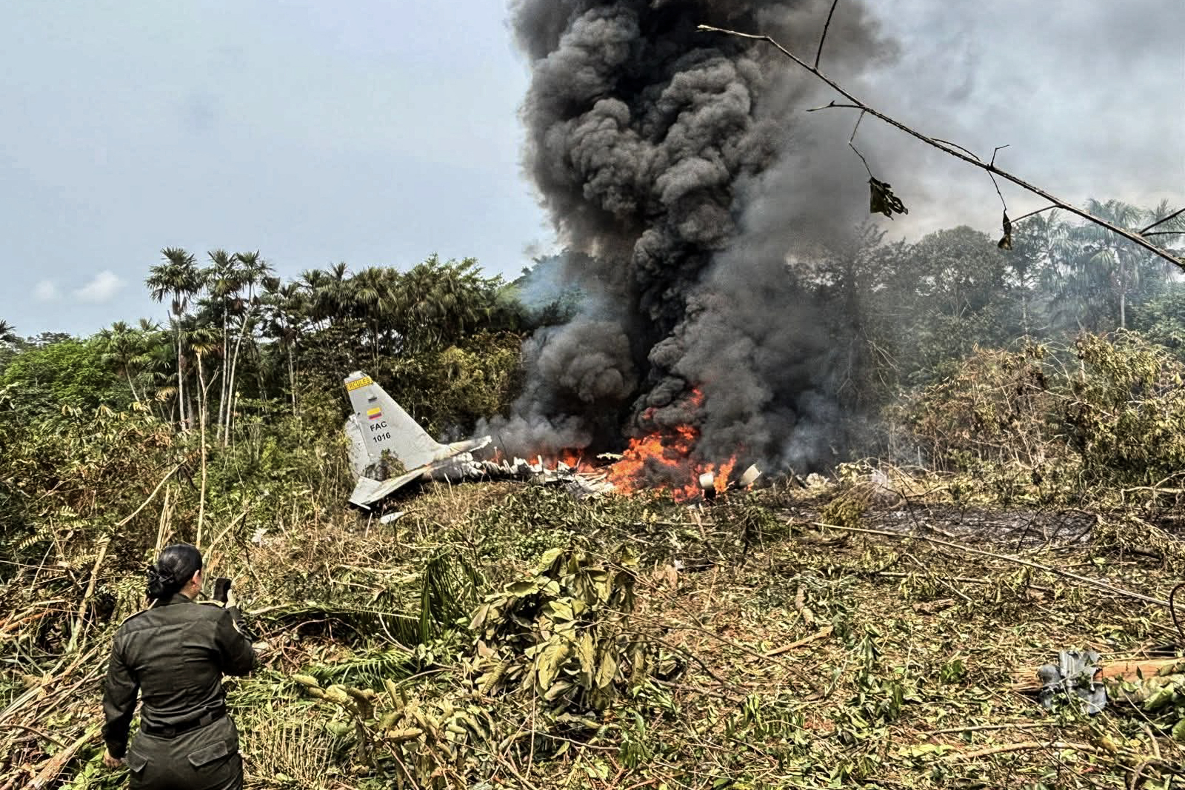 Flames and thick black smoke rise from the Colombian air force's C-130 Hercules that crashed during takeoff, in Puerto Leguizamo, Colombia
