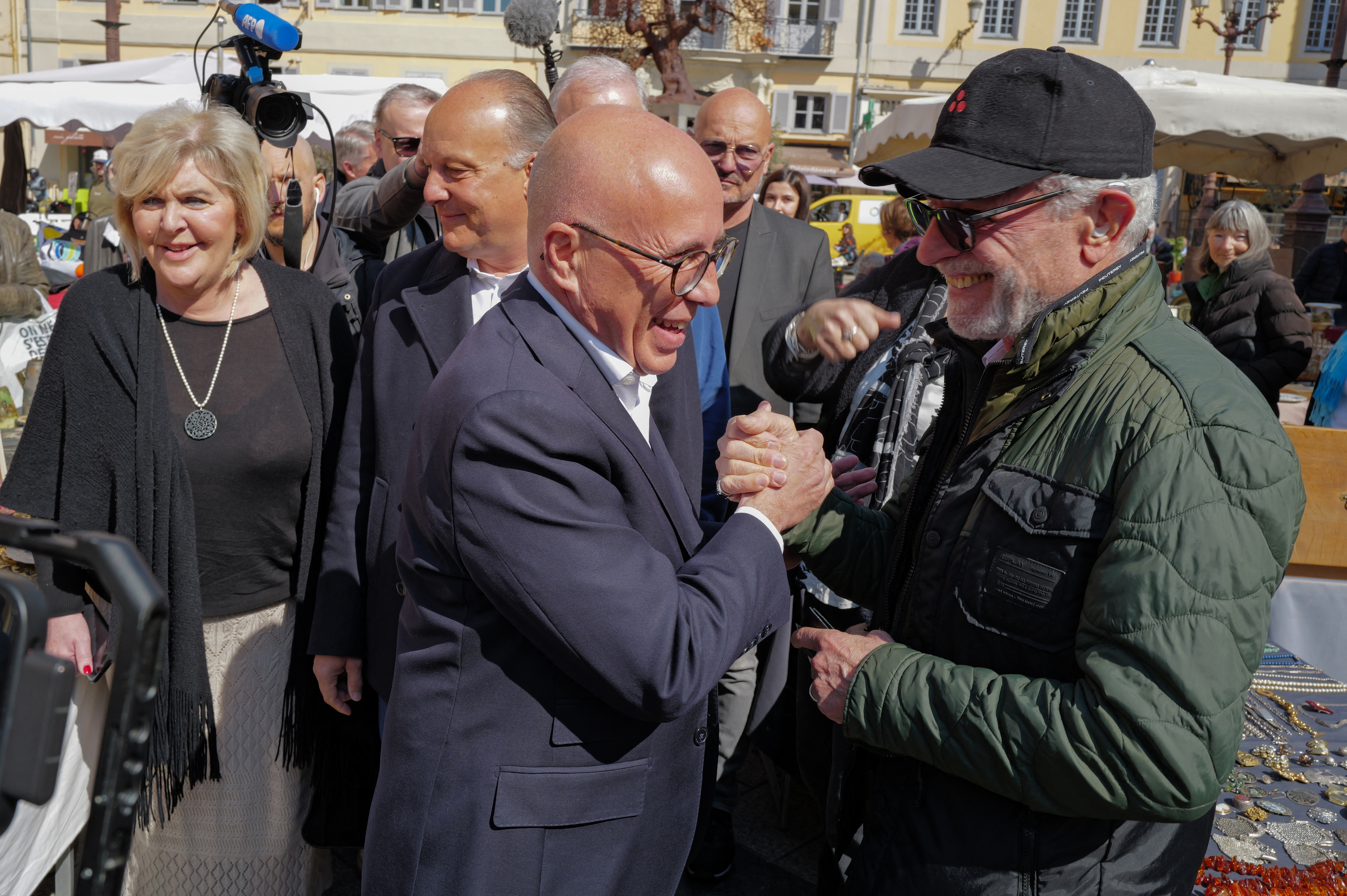 Newly elected mayor of Nice Eric Ciotti (2L) walks the streets to meet the residents the day after his election, in Nice, southeastern France on March 23, 2026. (Photo by Valery HACHE / AFP)
