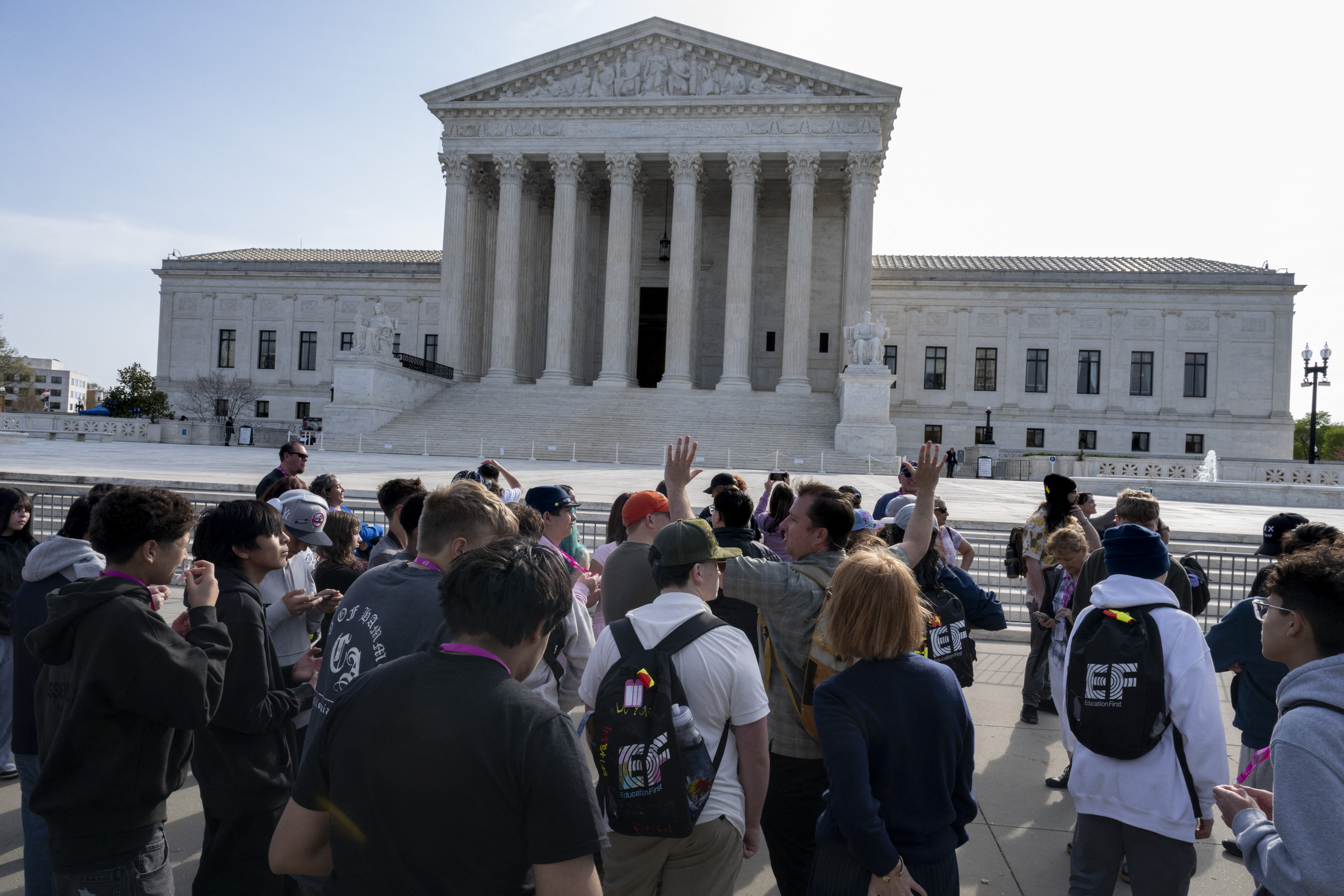 WASHINGTON, DC - MARCH 31: Students listen to a man explaining the significance of the statues adorning the U.S. Supreme Court building on March 31, 2026 in Washington, DC. The court found today that a Colorado law banning conversion therapy for gay and transgender minors likely violates free speech. Roberto Schmidt/Getty Images/AFP (Photo by ROBERTO SCHMIDT / GETTY IMAGES NORTH AMERICA / Getty Images via AFP)