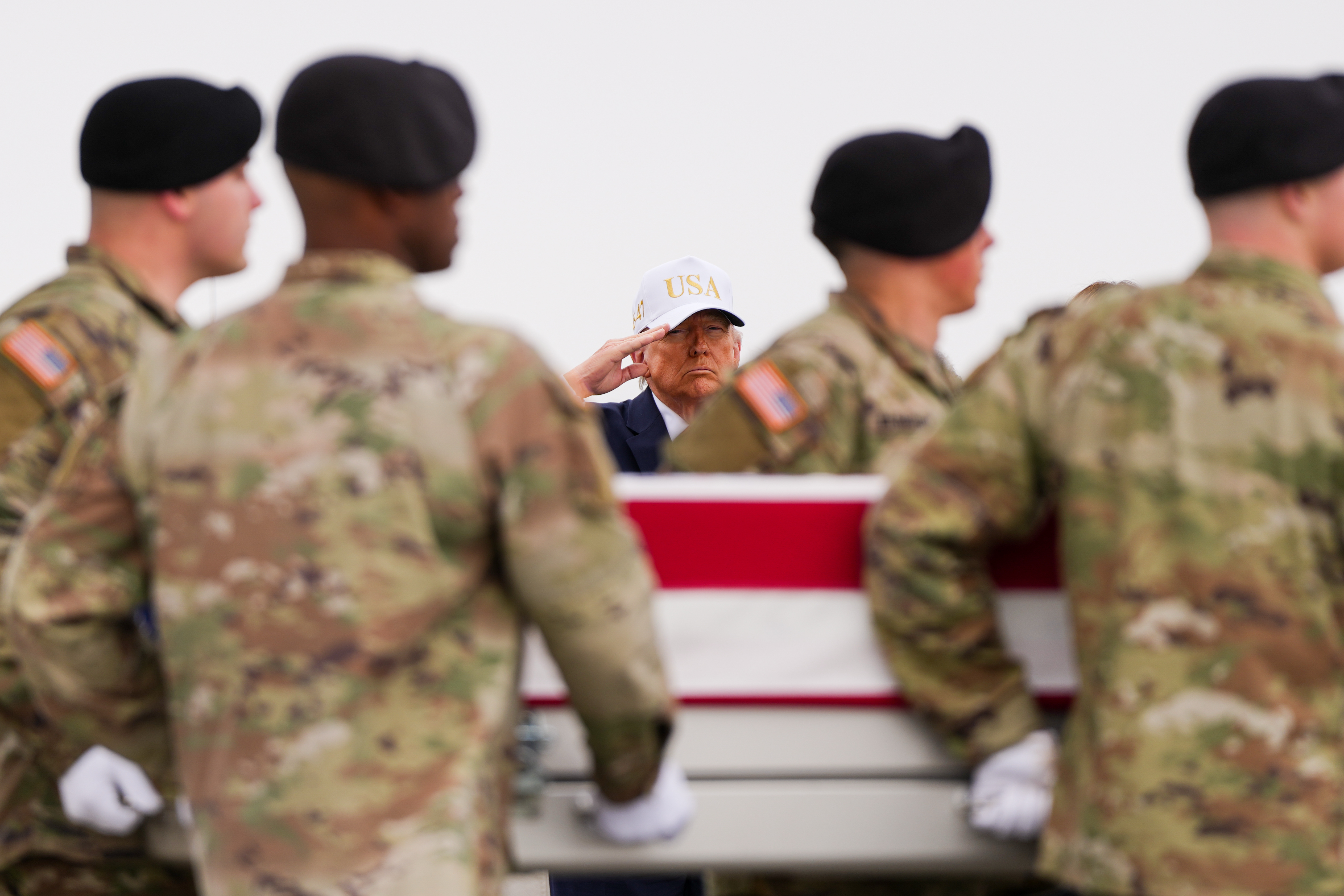 President Donald Trump salutes as an Army carry team moves a flag-draped transfer case with the remains of Chief Warrant Officer 3 Robert Marzan, 54, of Sacramento, who was killed in a drone strike at a command center in Kuwait after the U.S. and Israel launched its military campaign against Iran, during a casualty return, Saturday, March 7, 2026, at Dover Air Force Base, Del. (AP Photo/Julia Demaree Nikhinson)
