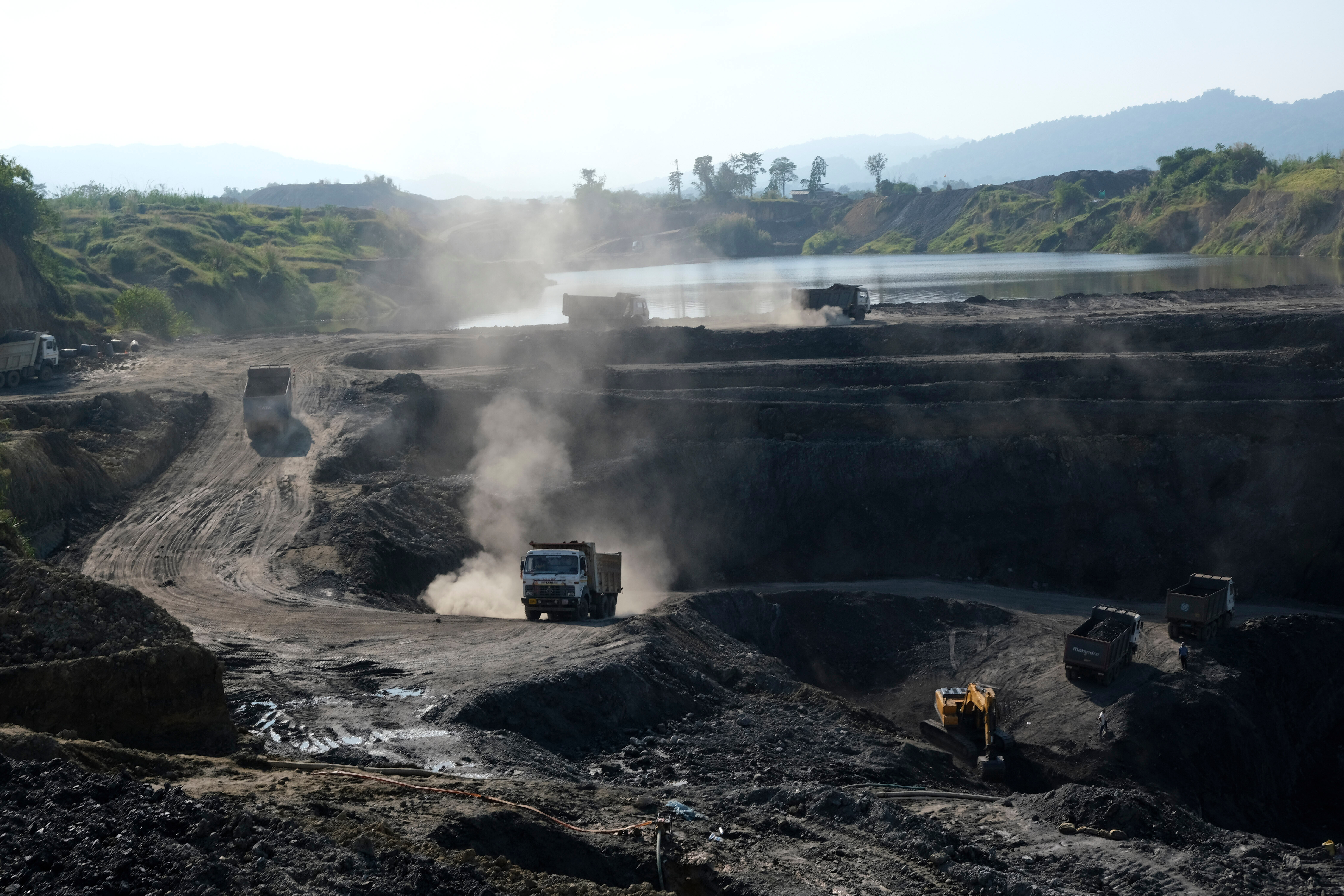 FILE - Machineries work at an open pit coal mining site in Tiru valley of Wokha district, in the northeastern state of Nagaland, India, Dec. 15, 2021. (AP Photo/Yirmiyan Arthur, File)