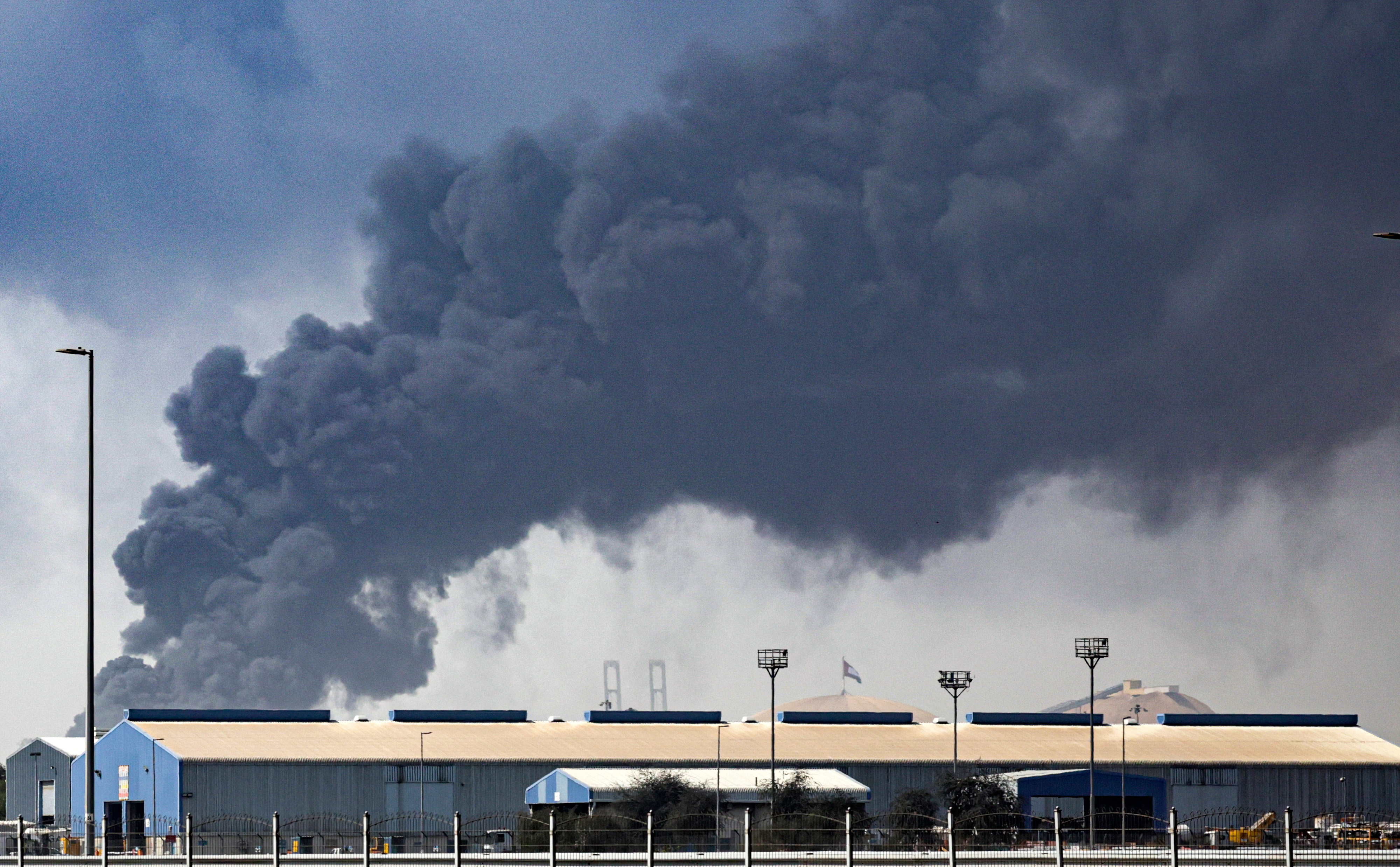 Thick black smoke billows into the air above the Jebel Ali port.