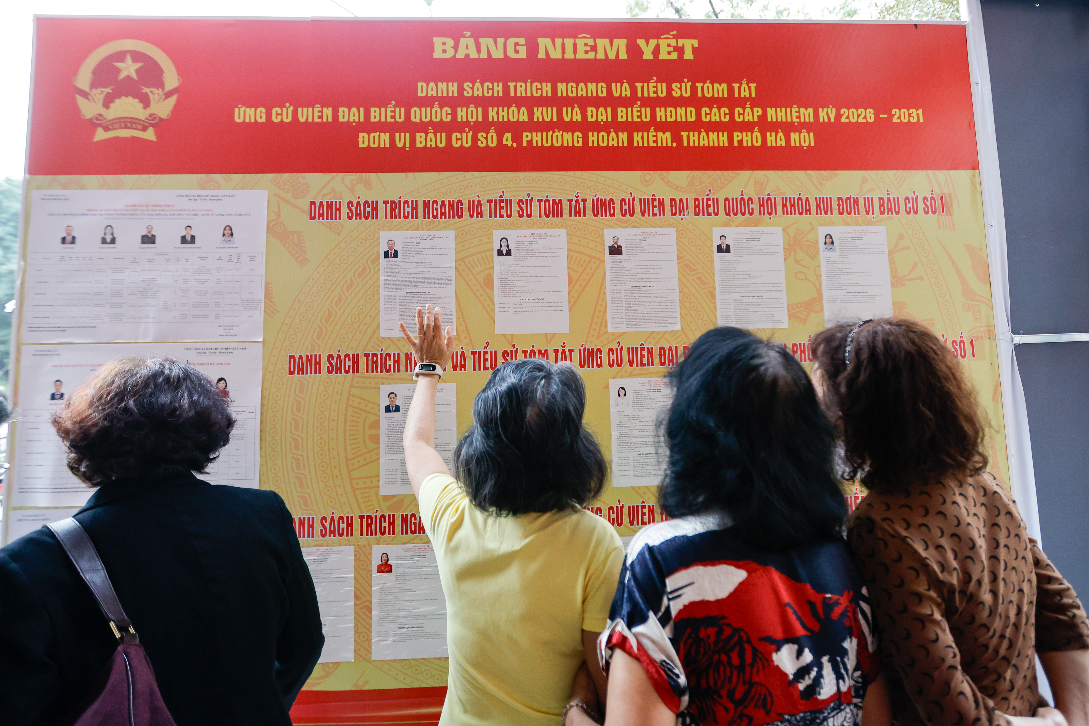 epa12820474 People look at the lists of candidates at a polling station in Hanoi, Vietnam 15 March 2026. Vietnam holds general elections for the 16th National Assembly and People's Councils at all levels for the 2026–2031 term on 15 March. EPA/LUONG THAI LINH