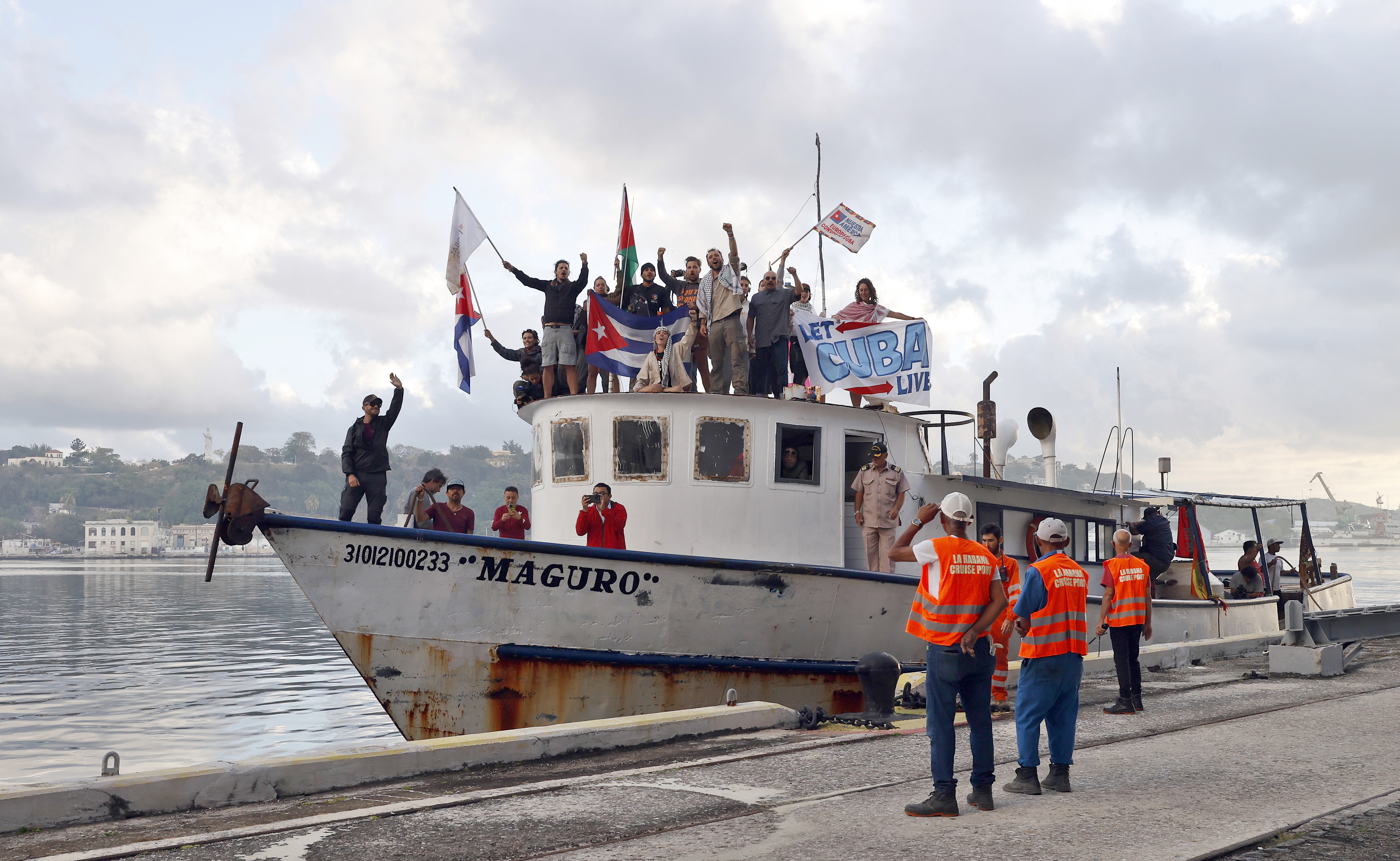 epa12846512 Members of the Nuestra America Convoy wave as they arrive at the port in Havana, Cuba, 24 March 2026. The Nuestra America Convoy, inspired by the Global Sumud Flotilla that delivered humanitarian aid to Gaza in 2025, aims to send a message of political support to Cuba, which has been subject to a US oil embargo since January 2026. EPA/Ernesto Mastrascusa