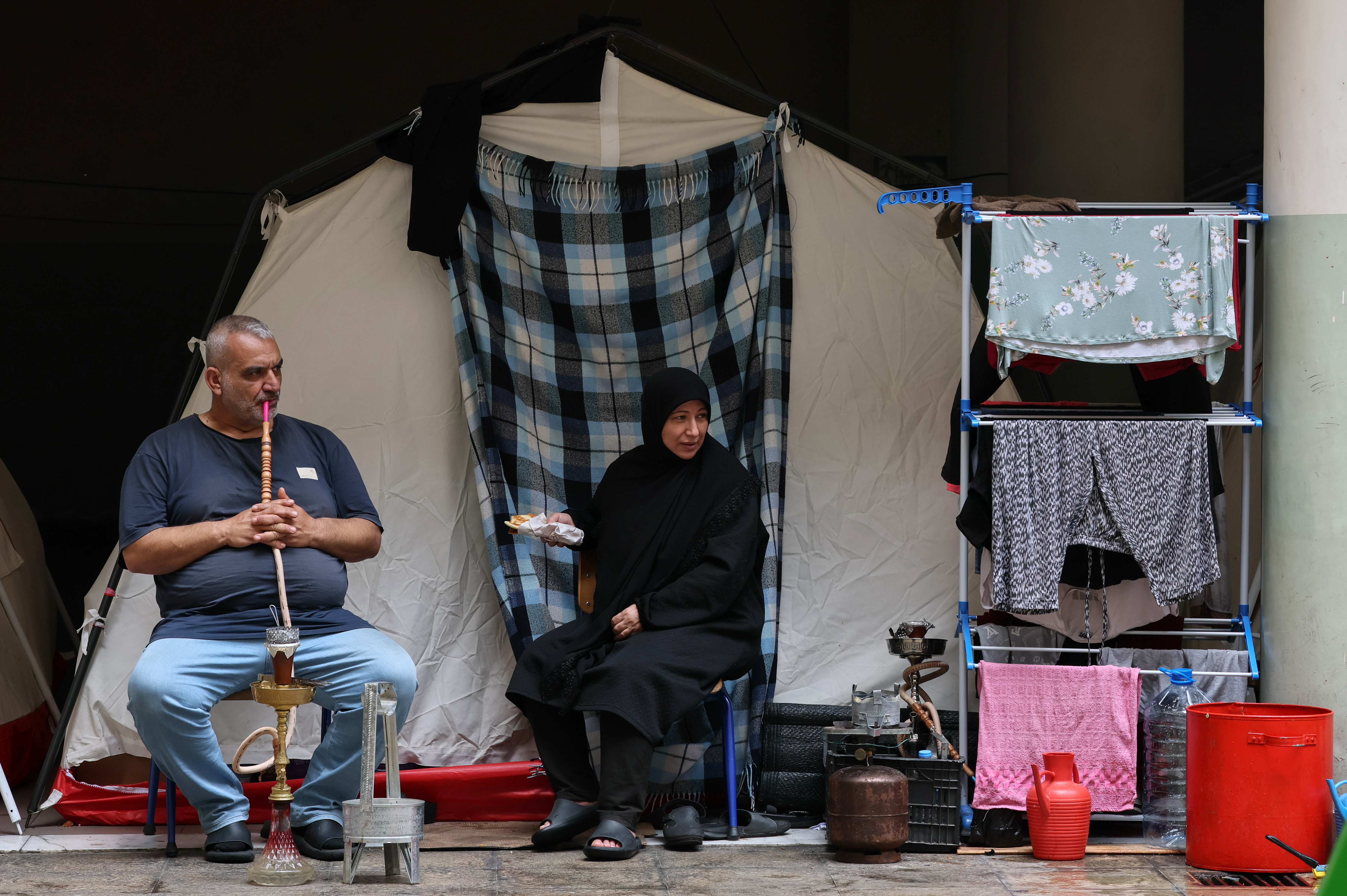 epa12853726 Displaced residents sit outside a tent in a local school after fleeing their homes in southern Lebanon following Israeli airstrikes, in Beirut, Lebanon, 27 March 2026. According to the Disaster Management Unit of the Lebanese government, as of 27 March 2026, more than 1,785,000 people have been internally displaced in collective shelters in Lebanon since the escalation began on 02 March. EPA/WAEL HAMZEH