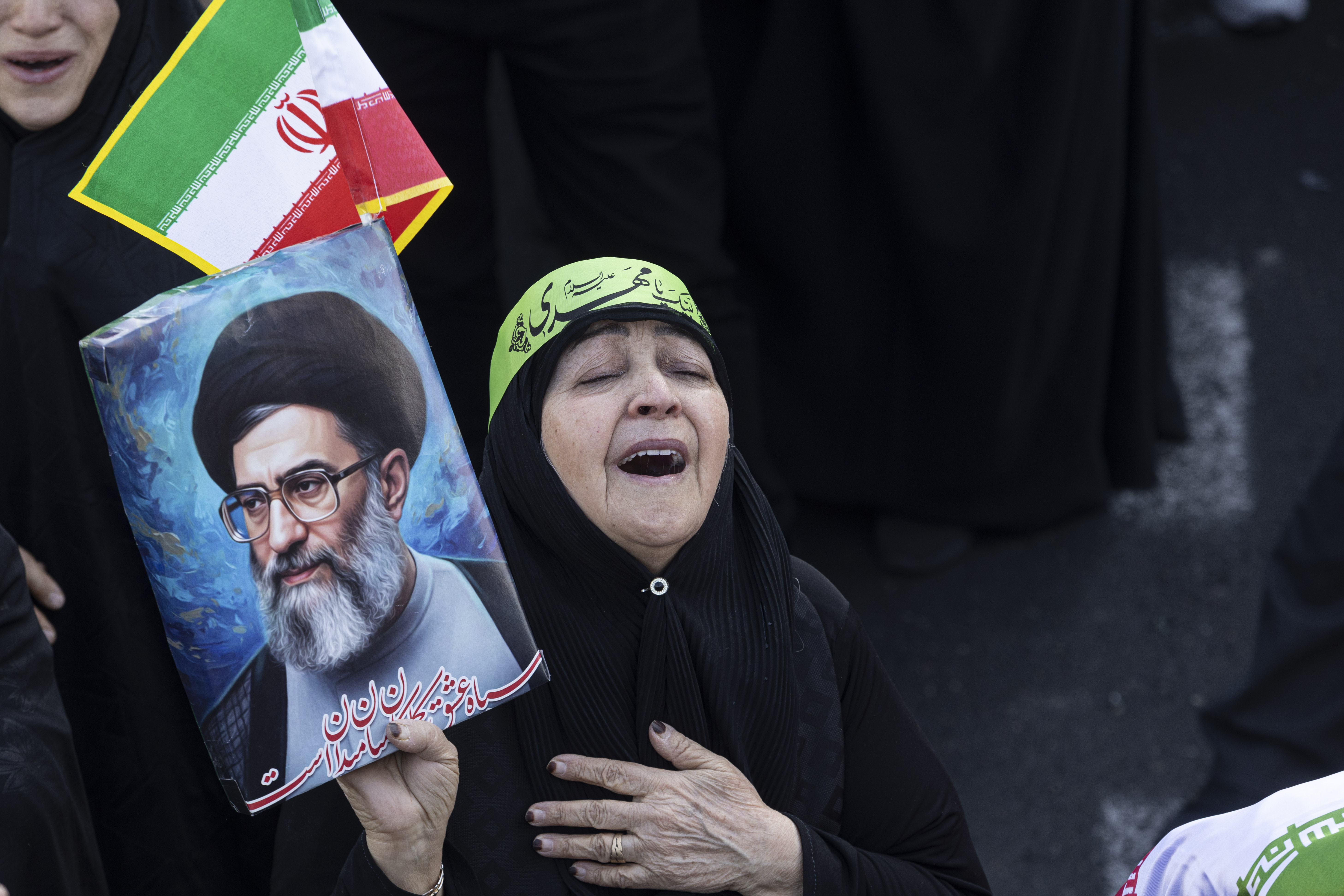TEHRAN, IRAN - MARCH 1: A woman wails and holds a poster as thousands of people gather in Enghelab Square for a pro-government demonstration after Iranian state media confirmed the death of Ayatollah Ali Khamenei on March 1, 2026 in Tehran, Iran. Iran's Supreme Leader, Ayatollah Ali Khamenei, was confirmed killed after the United States and Israel launched a joint attack on Iran on February 28. Iran retaliated by firing waves of missiles and drones at Israel, and targeting U.S. allies in the region. (Photo by Majid Saeedi/Getty Images)