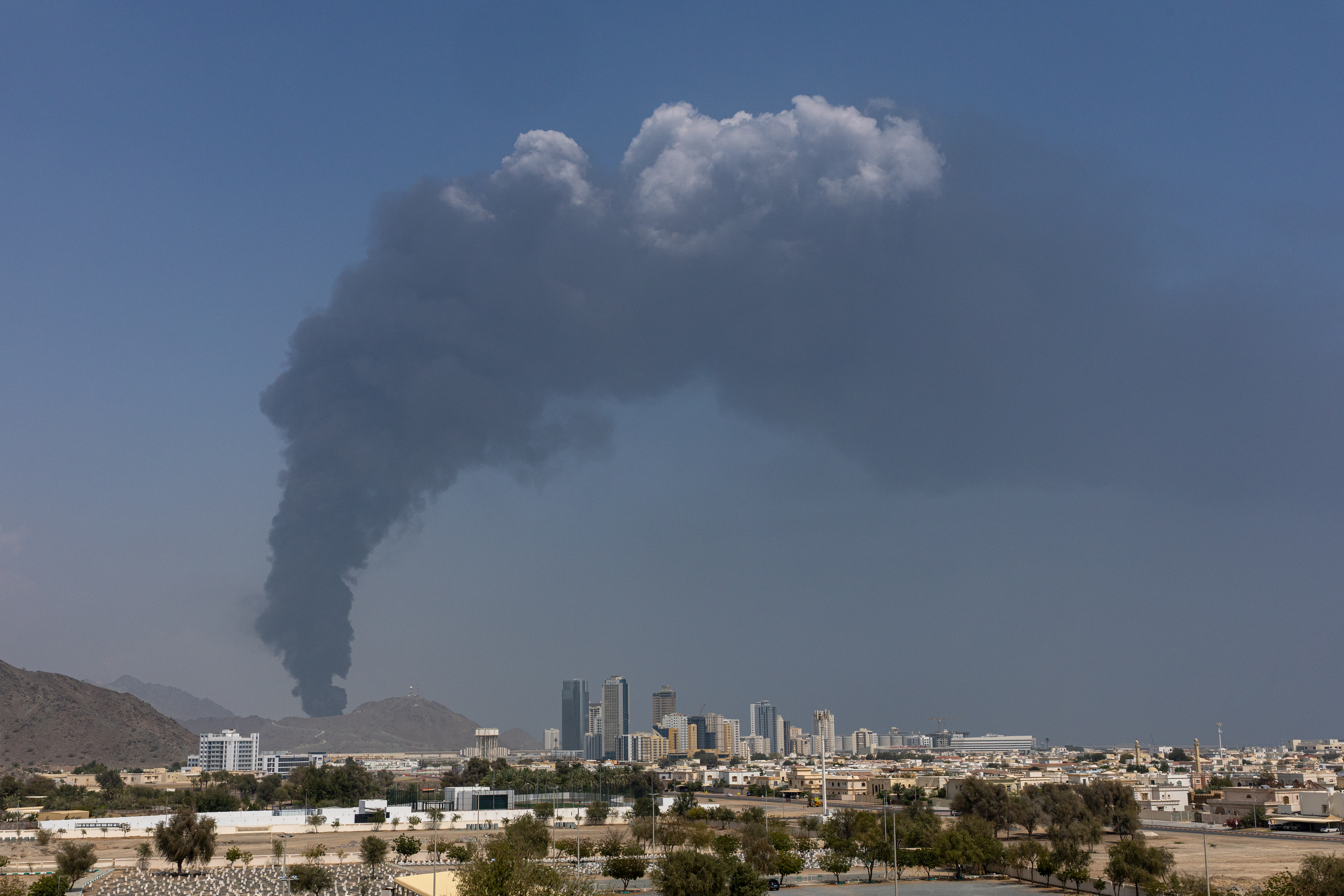 FUJAIRAH, UNITED ARAB EMIRATES - MARCH 05: Smoke rises after an explosion in the industrial zone, caused by debris after interception of a drone by air defence, according to the Fujairah media office on March 05, 2026, in Fujairah, United Arab Emirates. In recent days, Iran has fired drones and missiles toward the UAE and other Gulf states, following the joint U.S.-Israeli attack on Iran that began on February 28. Foreign ministers from the Gulf Co-operation Council (GCC) held an online meeting on March 1 and issued a statement saying they will take "all necessary measures" to defend their security and territory, condemning Iran's attacks as "heinous." (Photo by Christopher Pike/Getty Images)