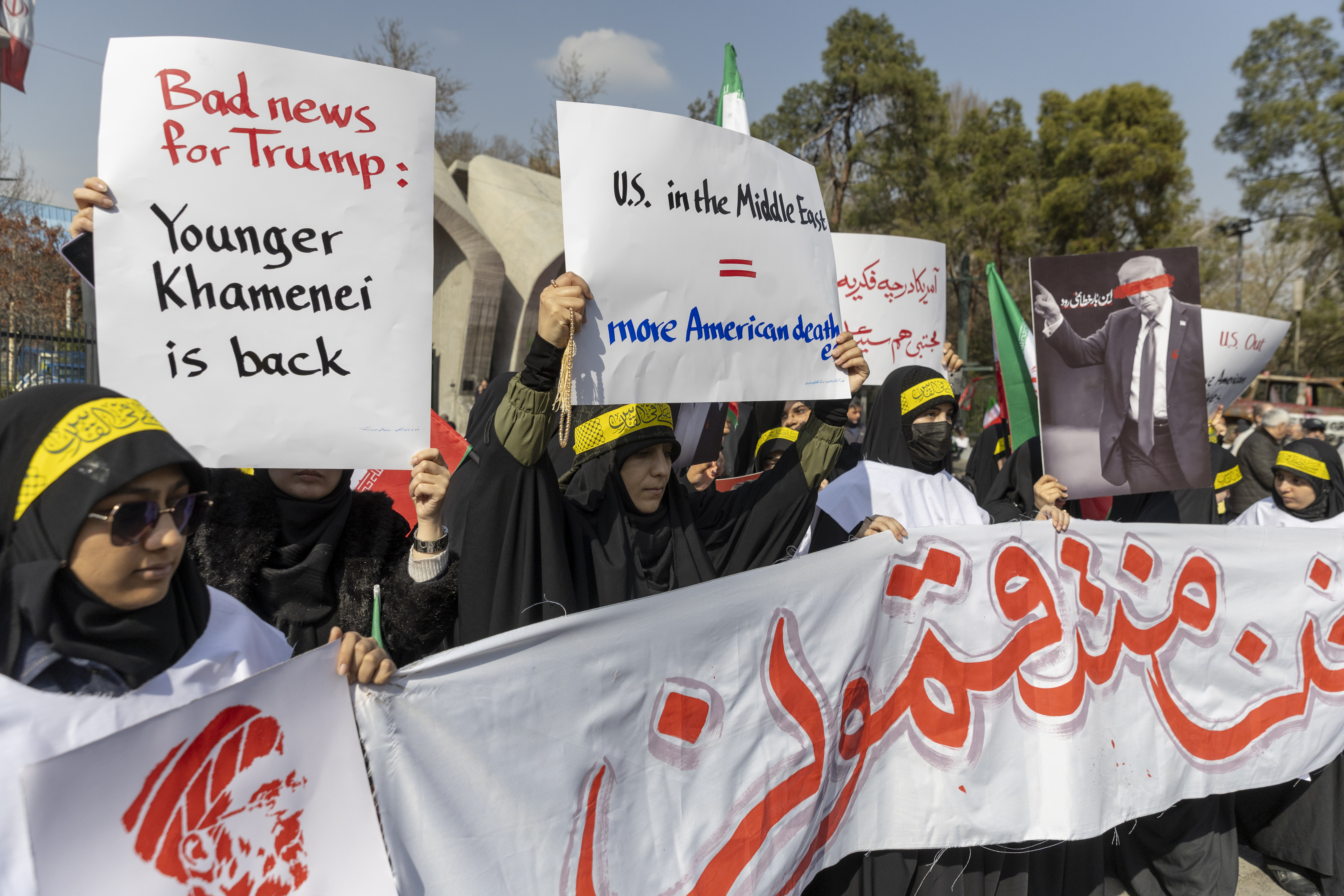 TEHRAN, IRAN - MARCH 11: Protesters show posters with Benjamin Netanyahu and Donald Trump as funerals are held for members of Iran's Revolutionary Guards Corps (IRGC) and other military figures at Enghelab Square on March 11, 2026 in Tehran, Iran. The deceased were killed during the joint U.S.-Israeli strikes in Iran that began on February 28. Iran has retaliated by firing waves of missiles and drones at Israel, and targeting U.S. allies in the region. (Photo by Majid Saeedi/Getty Images)