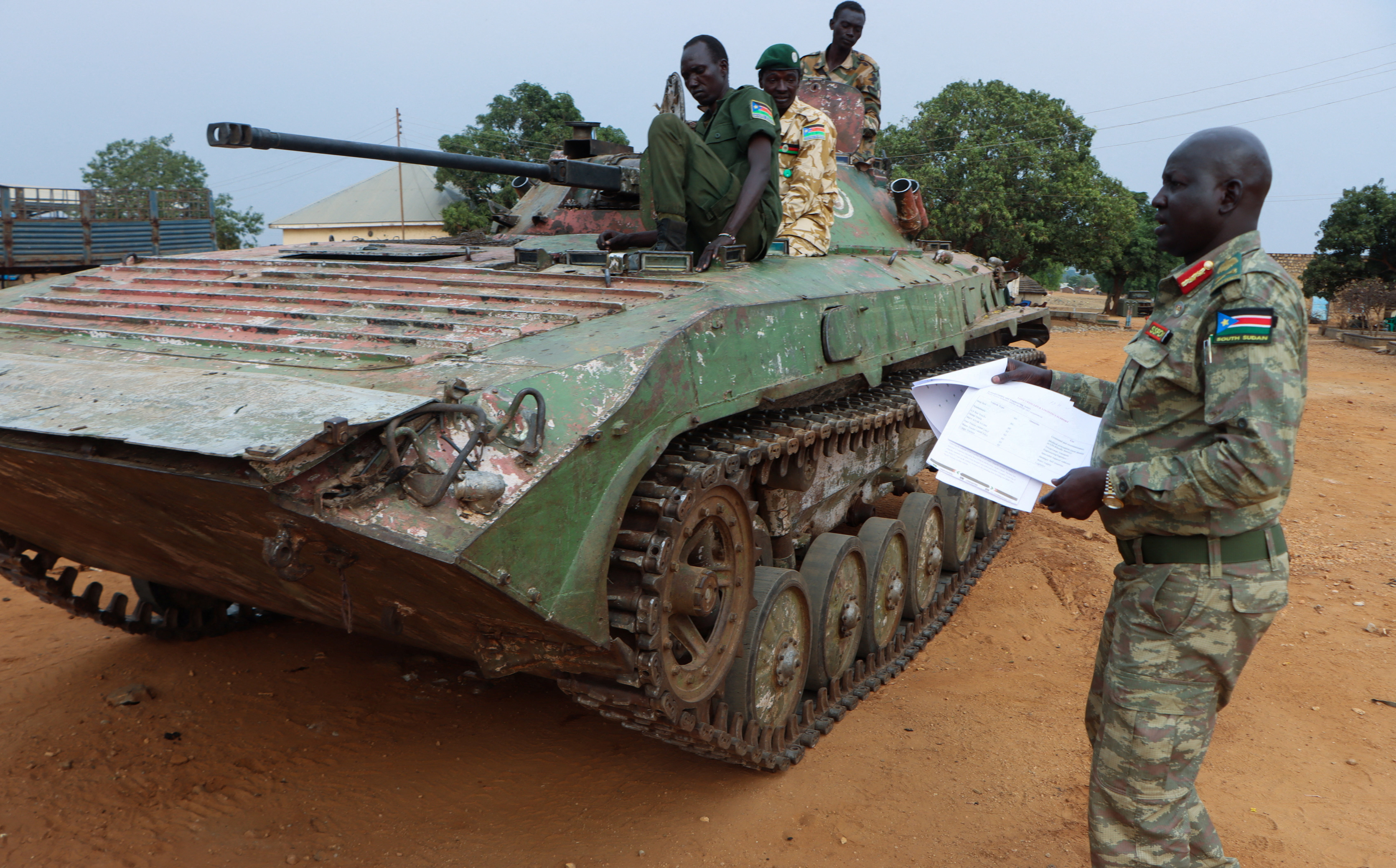 Major General Lul Ruai Koang the spokesperson for the South Sudan People's Defence Forces (SSPDF) shows journalists a captured BMP-2 infantry fighting vehicle nicknamed “Boorchar” seized by Sudan People's Liberation Movement-in-Opposition (SPLA-IO) fighters from an Indian peacekeeping unit serving under the United Nations Mission in South Sudan (UNMISS) during the 2013 conflict; after a press conference on the military operations in Akobo and ordering the withdrawal of UNMISS from the area; at the SSPDF armoury barracks in Juba, South Sudan March 6, 2026. REUTERS/Samir Bol