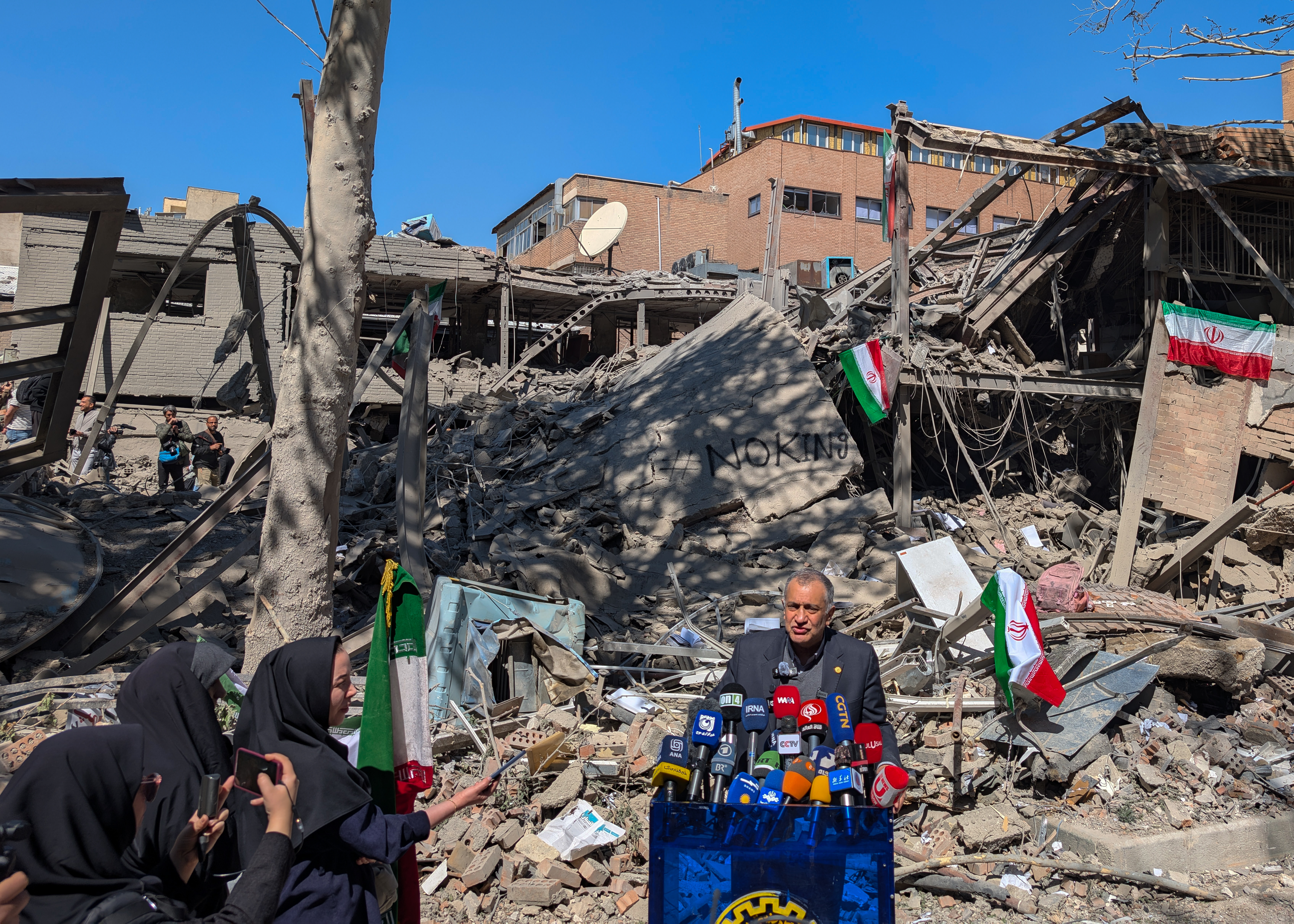 Destroyed building with people in the foreground
