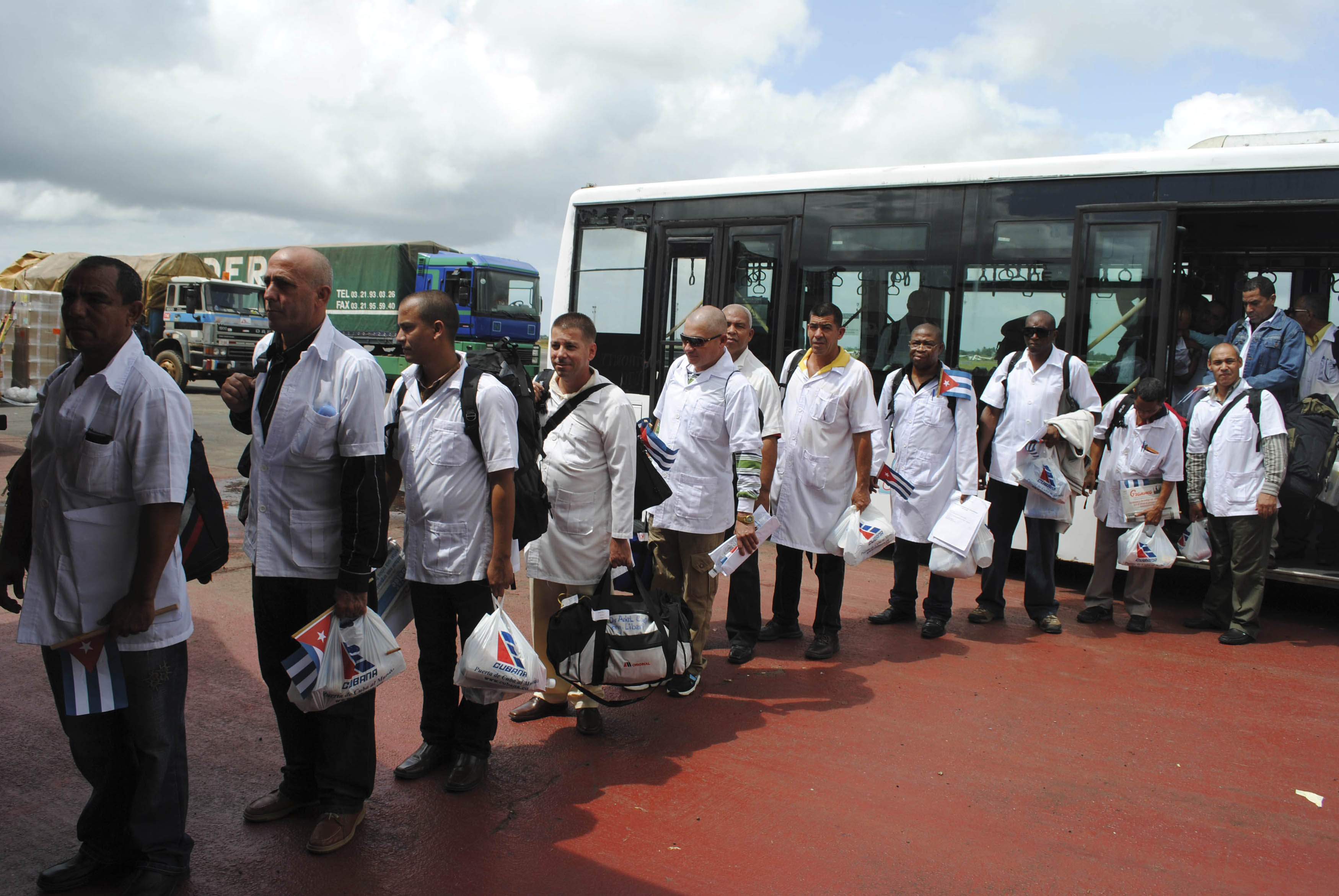 Cuban health workers arrive at Roberts Airport outside Monrovia October 22, 2014. A team of Cuban doctors and nurses arrived in Liberia on Wednesday to help to fight the worst outbreak of the deadly Ebola virus on record alongside a U.S. military mission deploying in the West Africa country. REUTERS/James Giahyue (LIBERIA - Tags: HEALTH DISASTER)