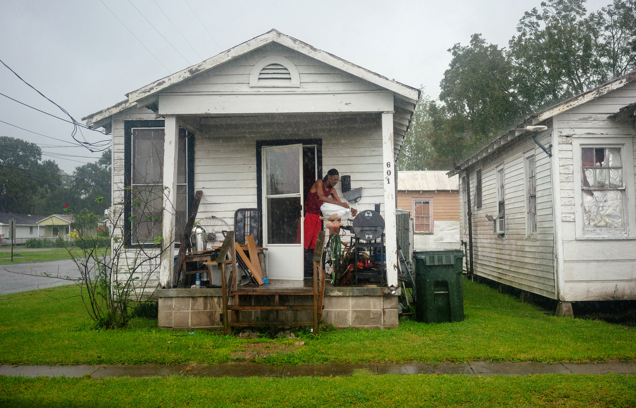 A resident covers some of his belongings as Hurricane Delta approaches in New Iberia, Louisiana, U.S., October 9, 2020. REUTERS/Kathleen Flynn