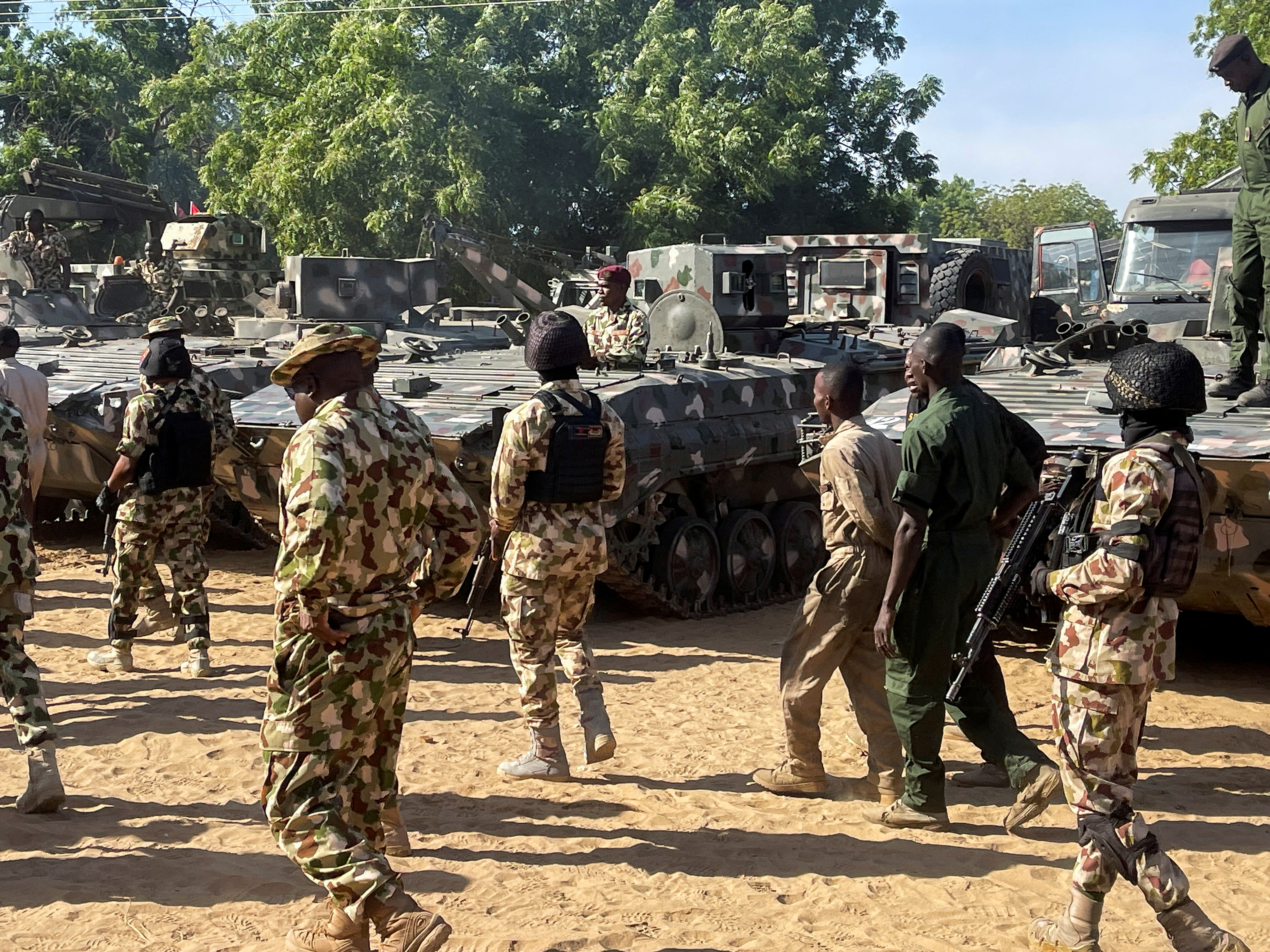Nigerian soldiers walks past military tanks in Maiduguri, Borno State, Nigeria on November 7, 2025.