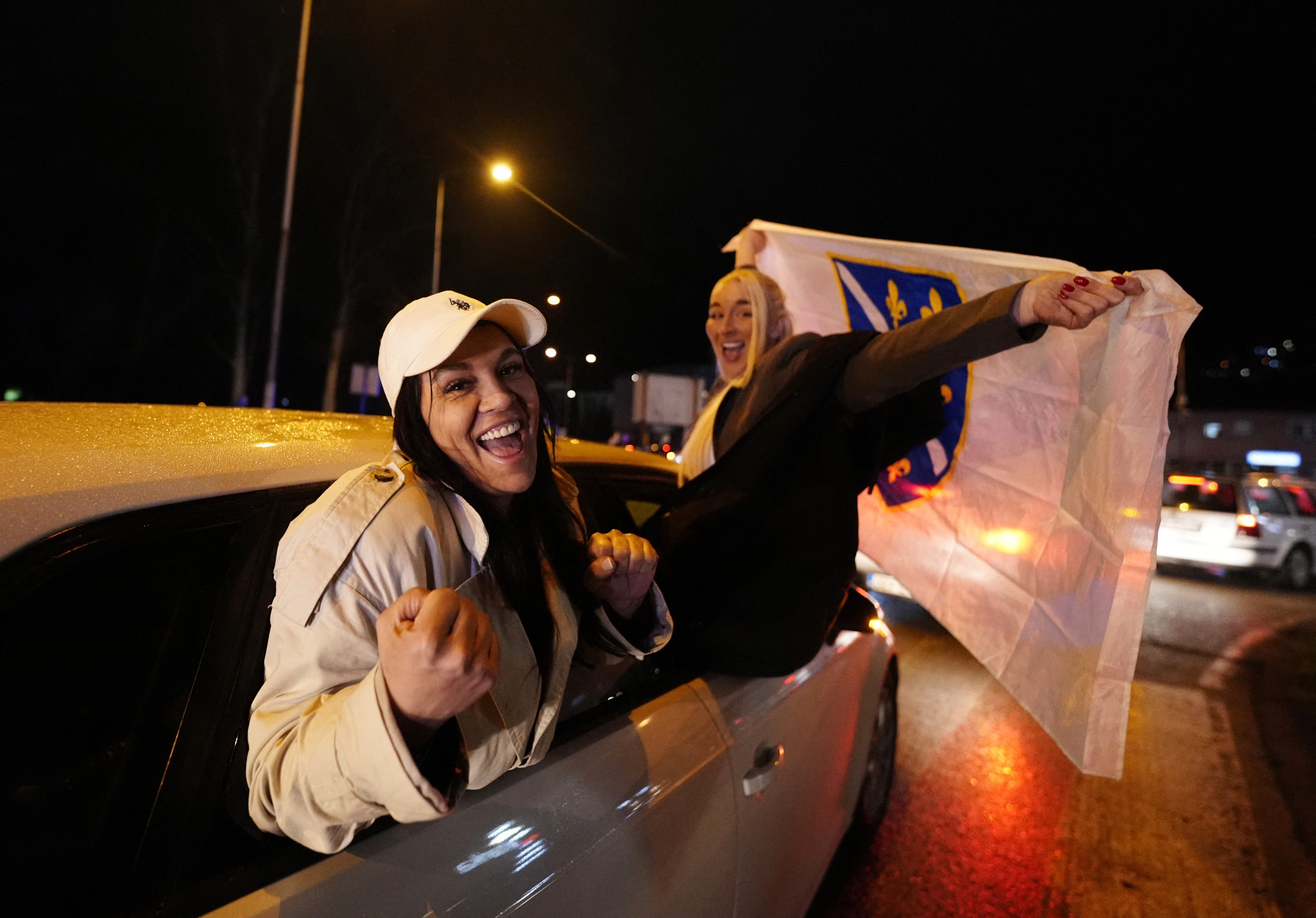 Soccer Football - FIFA World Cup - UEFA Qualifiers - Finals - Bosnia and Herzegovina v Italy - Zenica, Bosnia and Herzegovina - April 1, 2026 Bosnia and Herzegovina fans celebrate out of a car after qualifying for the FIFA World Cup outside the stadium REUTERS/Matteo Ciambelli
