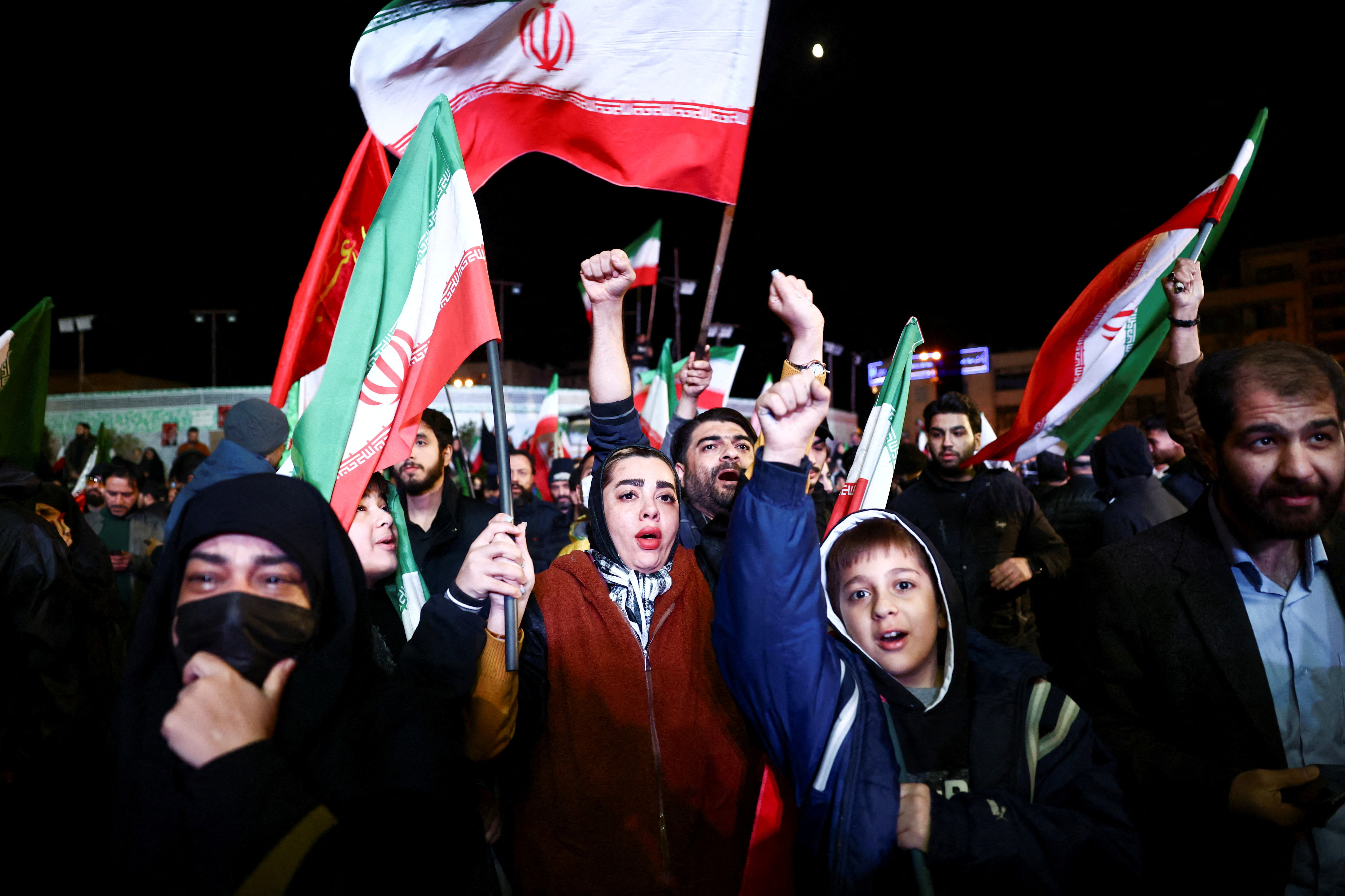 People wave flags as they gather after a two-week ceasefire in the Iran war was announced, in Tehran, Iran, April 8, 2026.
