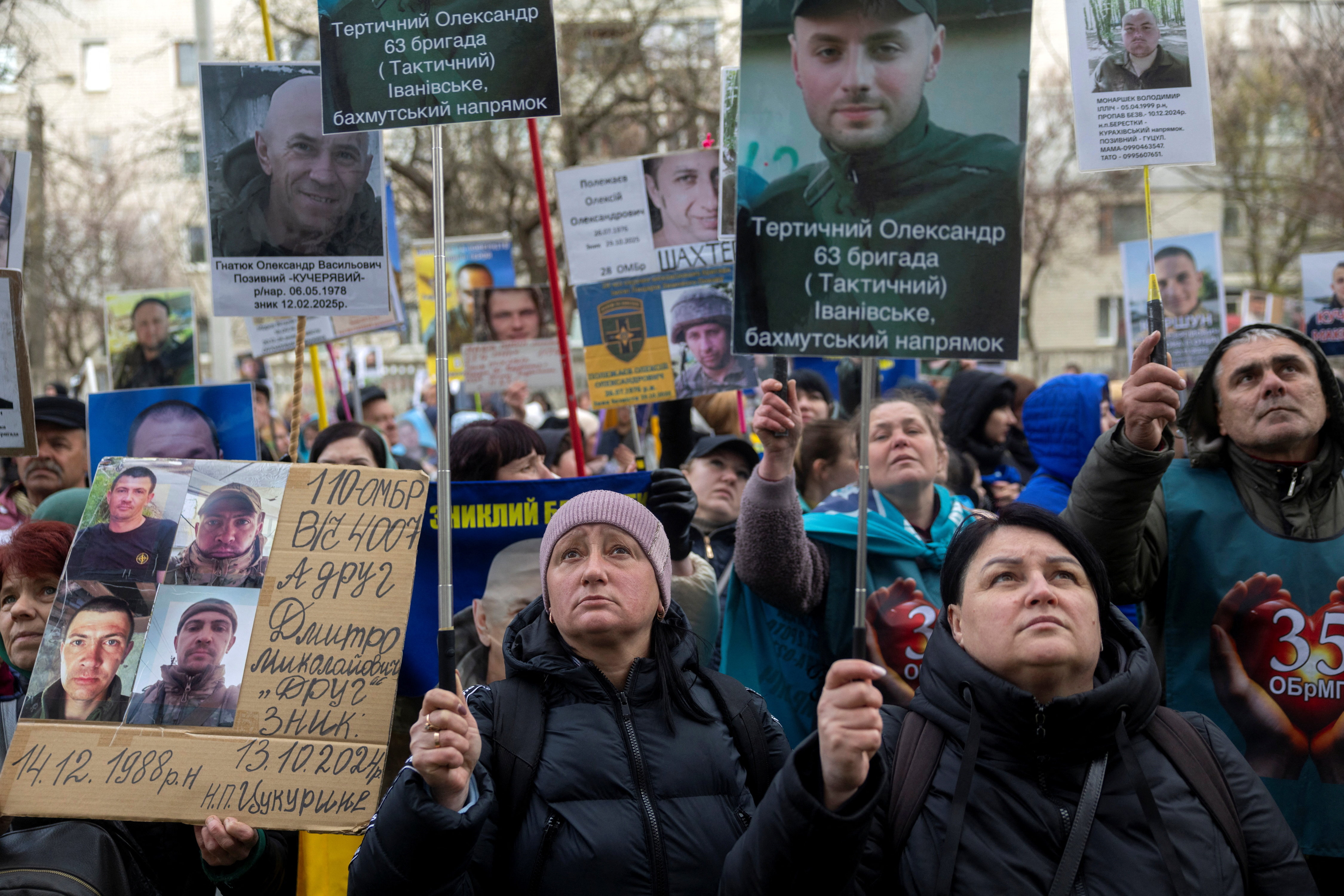 People hold pictures of missing Ukrainian soldier
