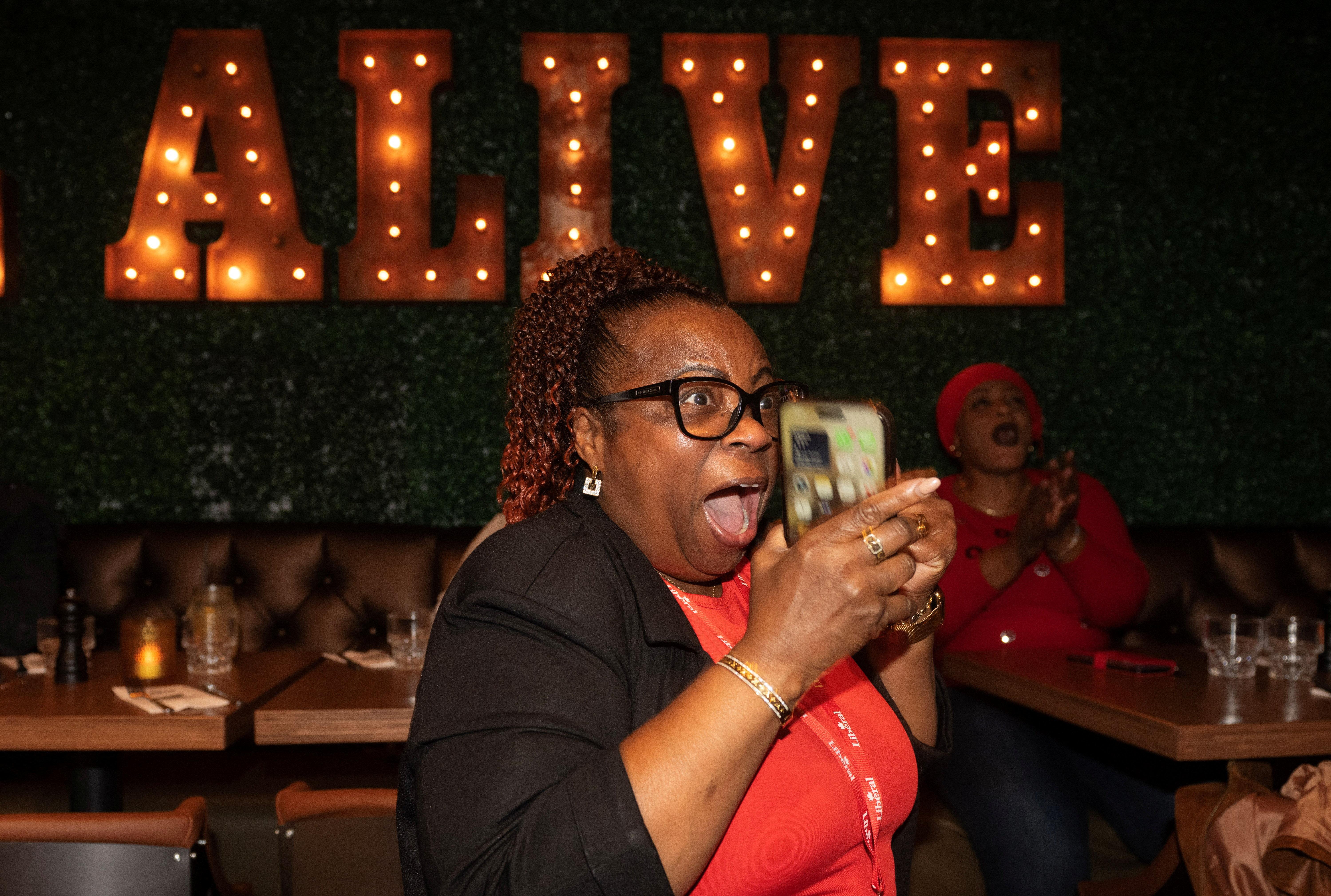 Supporters of Liberal Party candidate Tatiana Auguste react as results are posted after the by-election in Terrebonne, Quebec