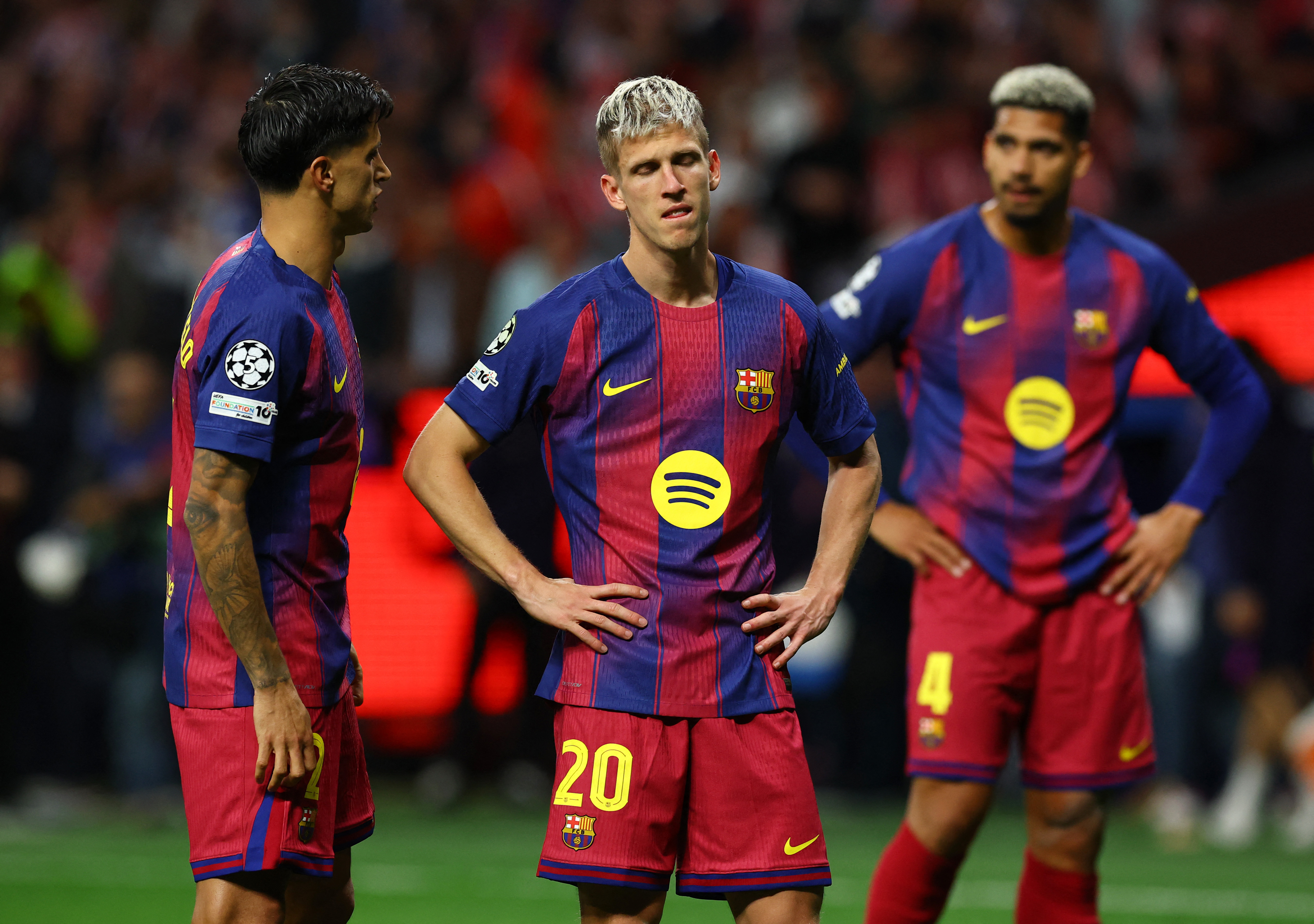 Barcelona's Joao Cancelo and Dani Olmo look dejected after the Atletico Madrid Champions League match