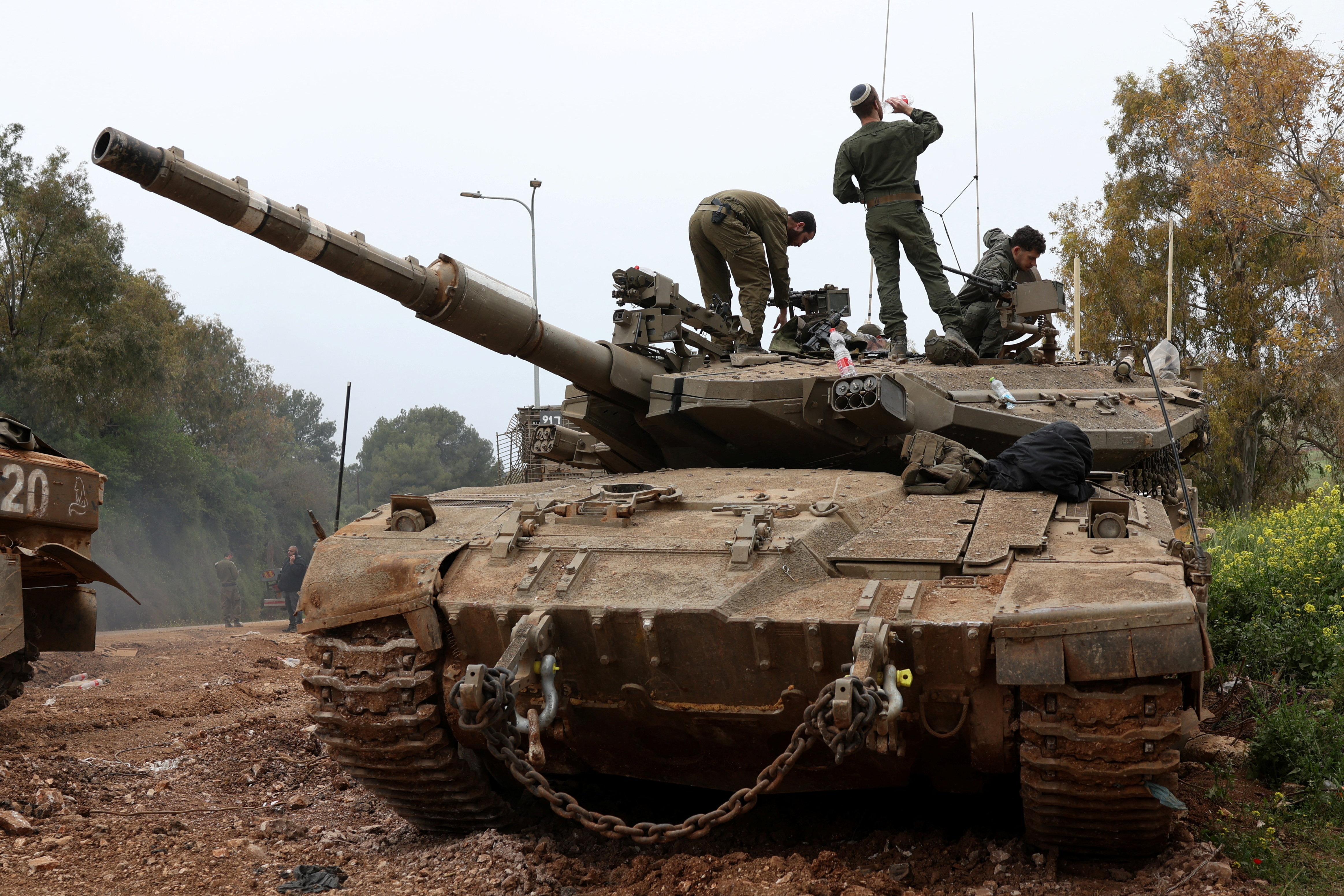 Israeli soldiers stand on top of a tank in northern Israel, near the Israel-Lebanon border, April 15, 2026. REUTERS/Florion Goga