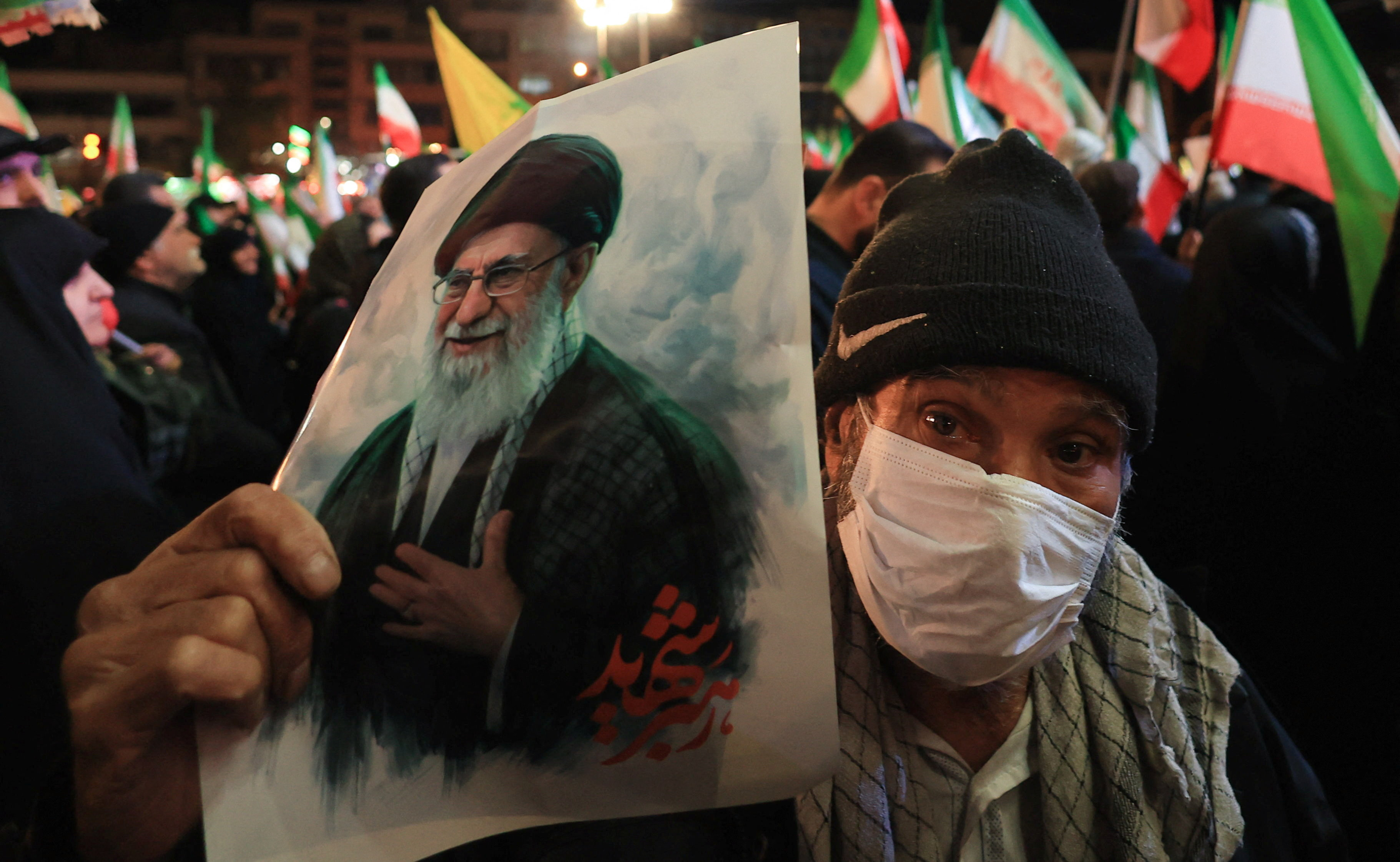 A man holds a poster of Iran’s late Supreme Leader Ayatollah Ali Khamenei during an anti-U.S. and anti-Israel rally