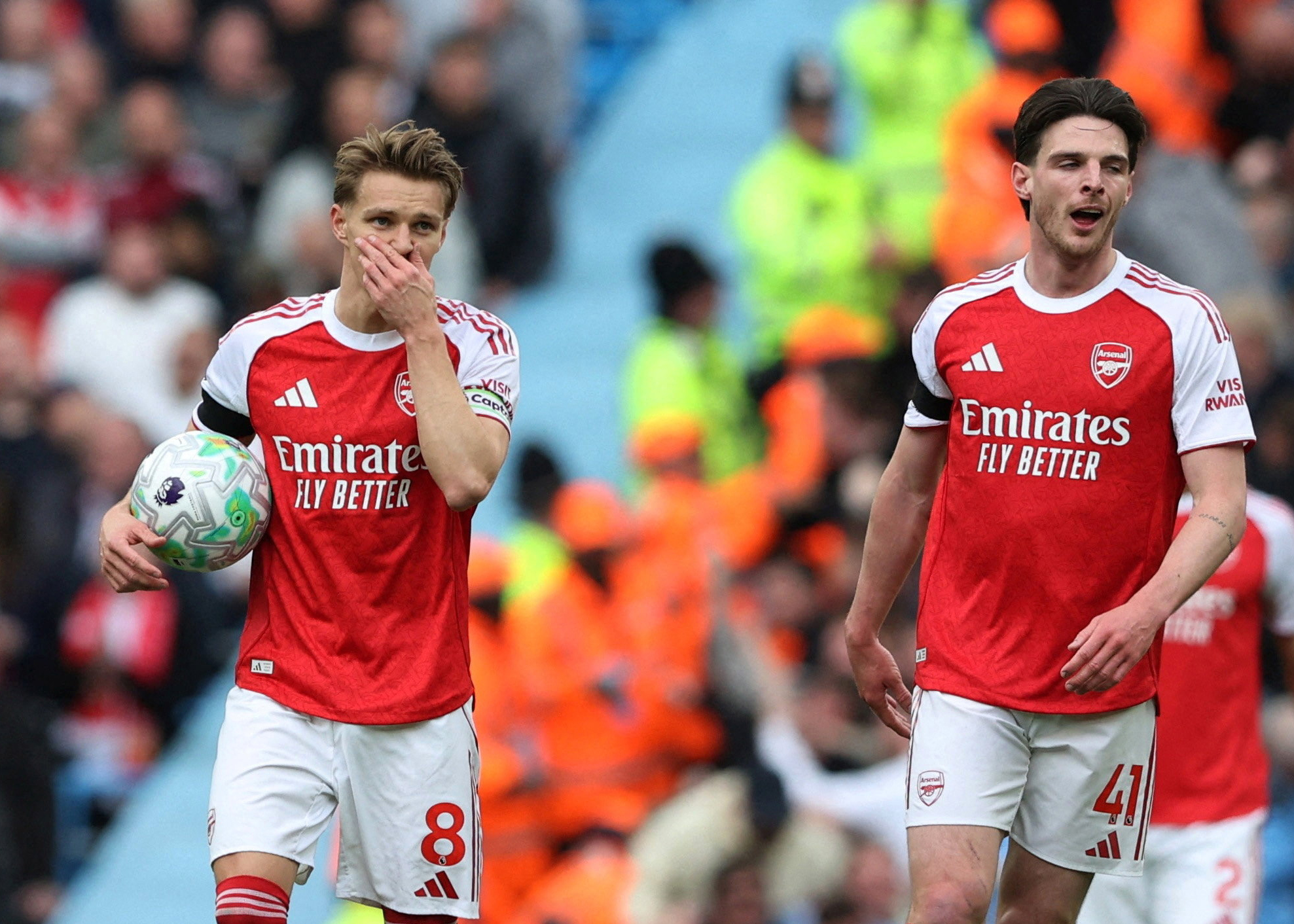 Soccer Football - Premier League - Manchester City v Arsenal - Etihad Stadium, Manchester, Britain - April 19, 2026 Arsenal's Martin Odegaard and Declan Rice look dejected after Manchester City's Rayan Cherki scores their first goal REUTERS/Scott Heppell EDITORIAL USE ONLY. NO USE WITH UNAUTHORIZED AUDIO, VIDEO, DATA, FIXTURE LISTS, CLUB/LEAGUE LOGOS OR 'LIVE' SERVICES. ONLINE IN-MATCH USE LIMITED TO 120 IMAGES, NO VIDEO EMULATION. NO USE IN BETTING, GAMES OR SINGLE CLUB/LEAGUE/PLAYER PUBLICATIONS. PLEASE CONTACT YOUR ACCOUNT REPRESENTATIVE FOR FURTHER DETAILS.. TPX IMAGES OF THE DAY