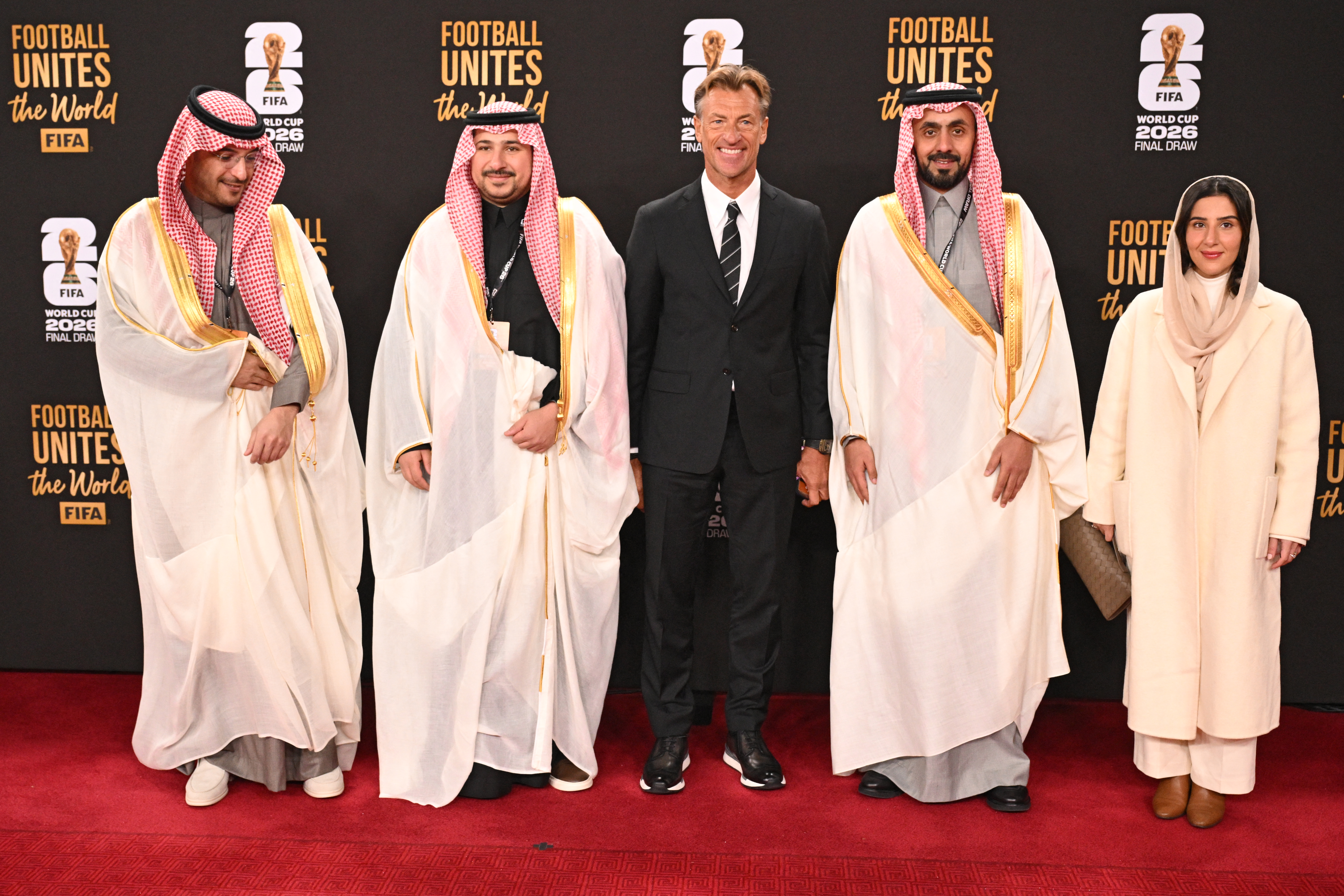 Saudi Arabia's French head coach Herve Renard (C) and members of Saudi Arabia's delegation pose on the red carpet upon arrival to attend the draw for the 2026 FIFA Football World Cup taking place in the US, Canada and Mexico, at the Kennedy Center, in Washington, DC, on December 5, 2025. (Photo by Roberto SCHMIDT / AFP)