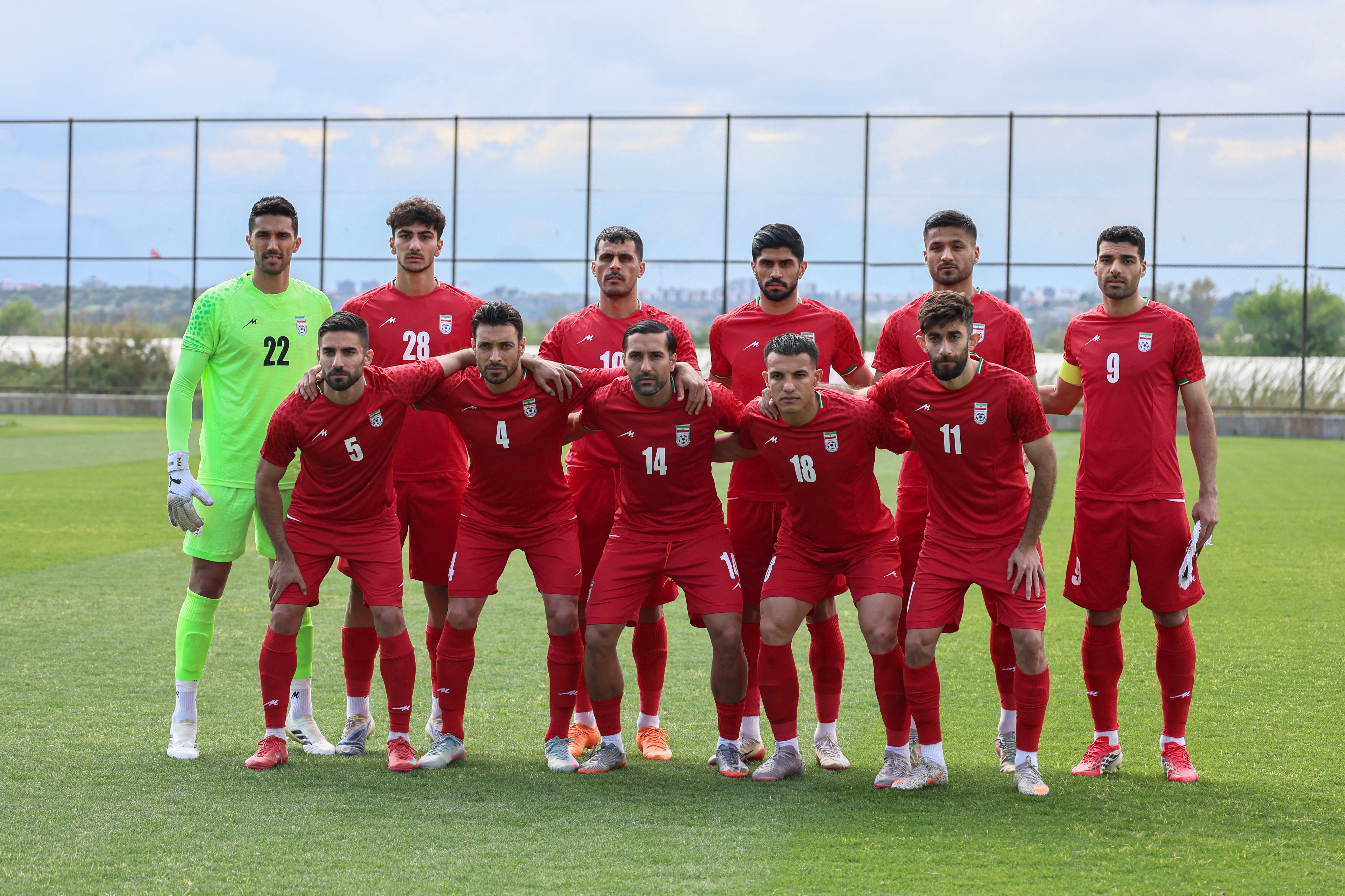 Iran's national football team's players pose on the pitch before a friendly match between Iran and Costa Rica, in Antalya, southern Turkey, on March 31, 2026. FIFA's president told AFP that Iran "will be at the World Cup" despite the Middle East war. (Photo by Adem ALTAN / AFP)