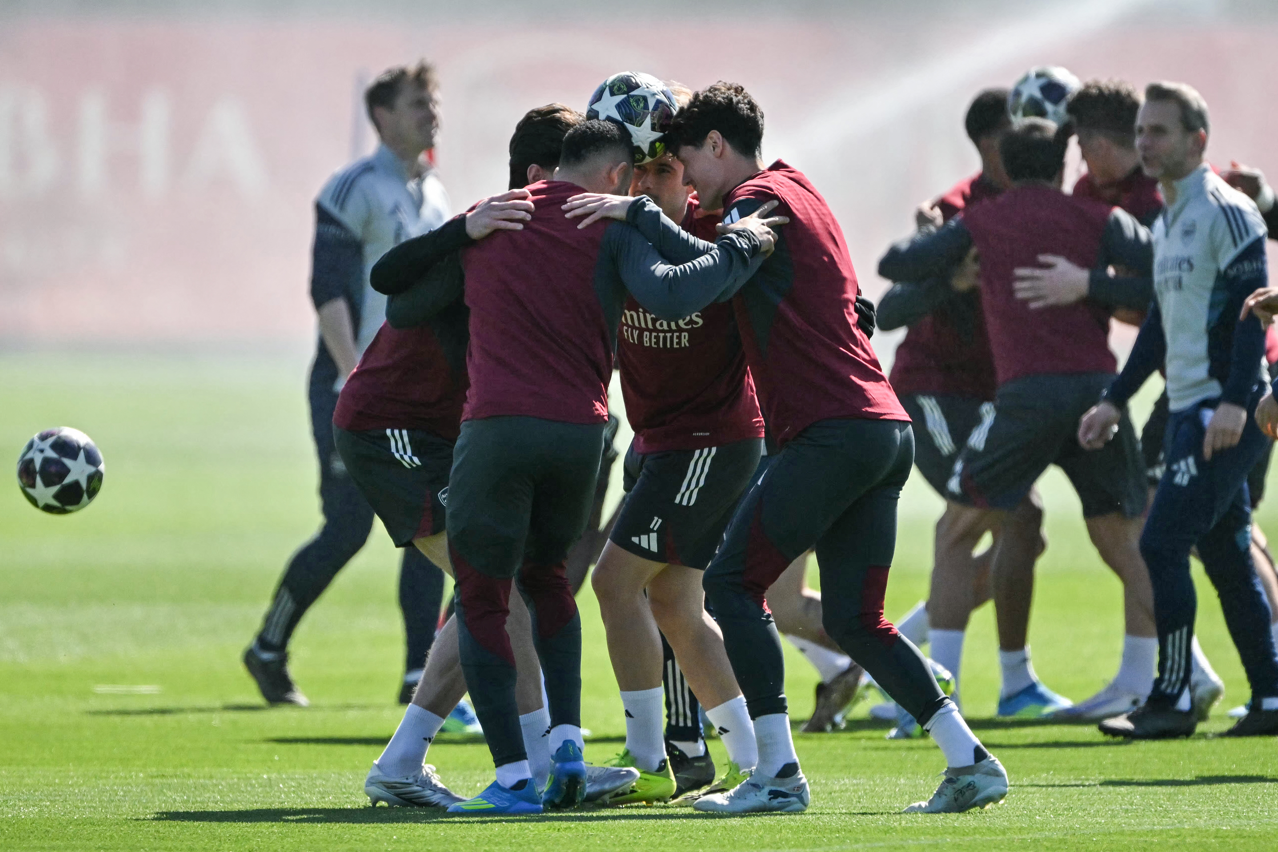 Players try to transport the ball without dropping it as they take part in a team training session at the Arsenal training centre in London Colney, north of London, on April 6, 2026, on the eve of their UEFA Champions League, quarter-final, first-leg football match against Sporting in Portugal. (Photo by Glyn KIRK / AFP)