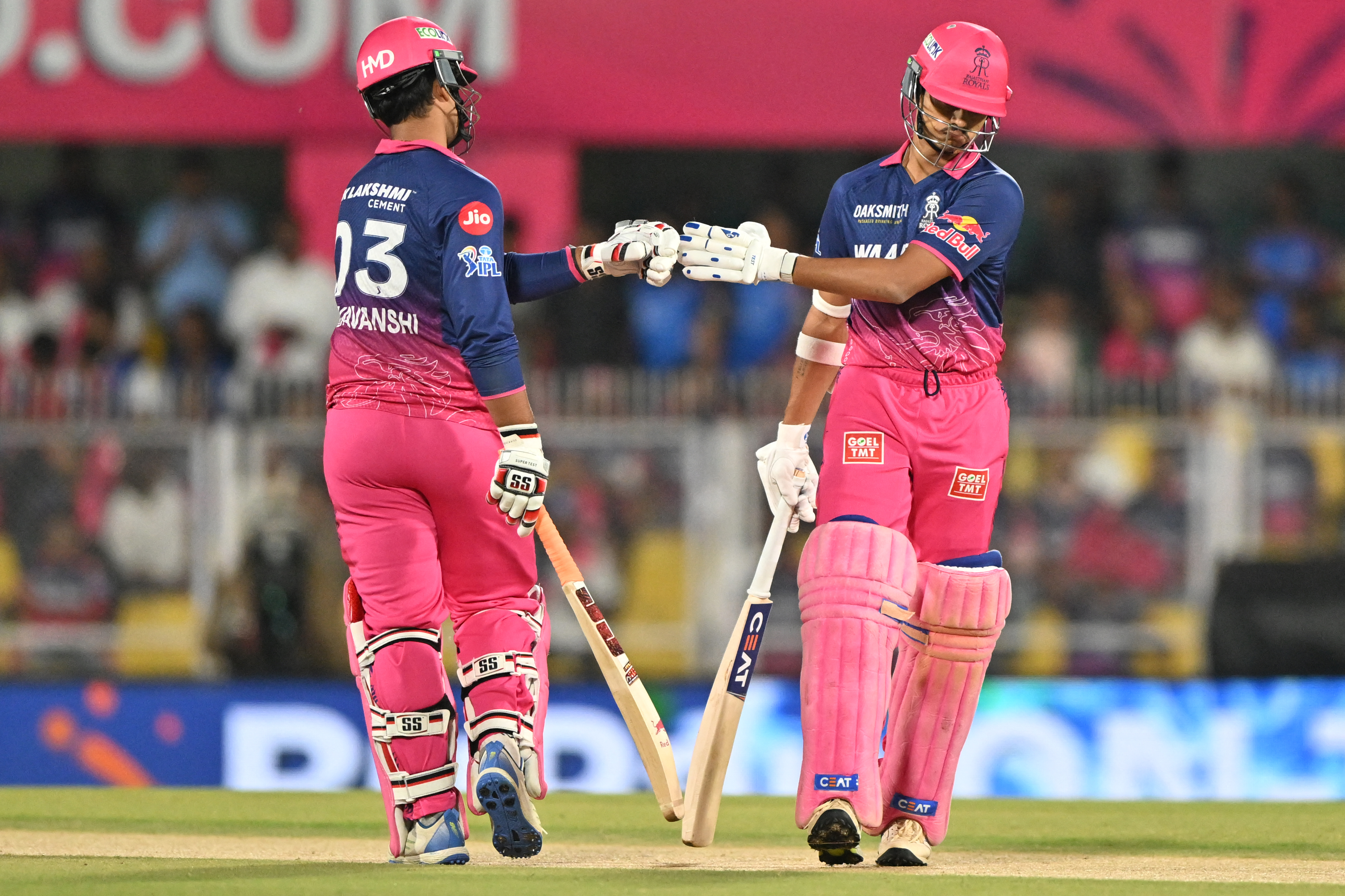Rajasthan Royals' Indian cricket players Yashasvi Jaiswal and Vaibhav Suryavanshi bump fists during the 2026 Indian Premier League (IPL) T20 match between Rajasthan Royals and Mumbai Indians at the Barsapara Cricket Stadium in Guwahati on April 7, 2026. (Photo by BIJU BORO / AFP) / -- IMAGE RESTRICTED TO EDITORIAL USE - STRICTLY NO COMMERCIAL USE --