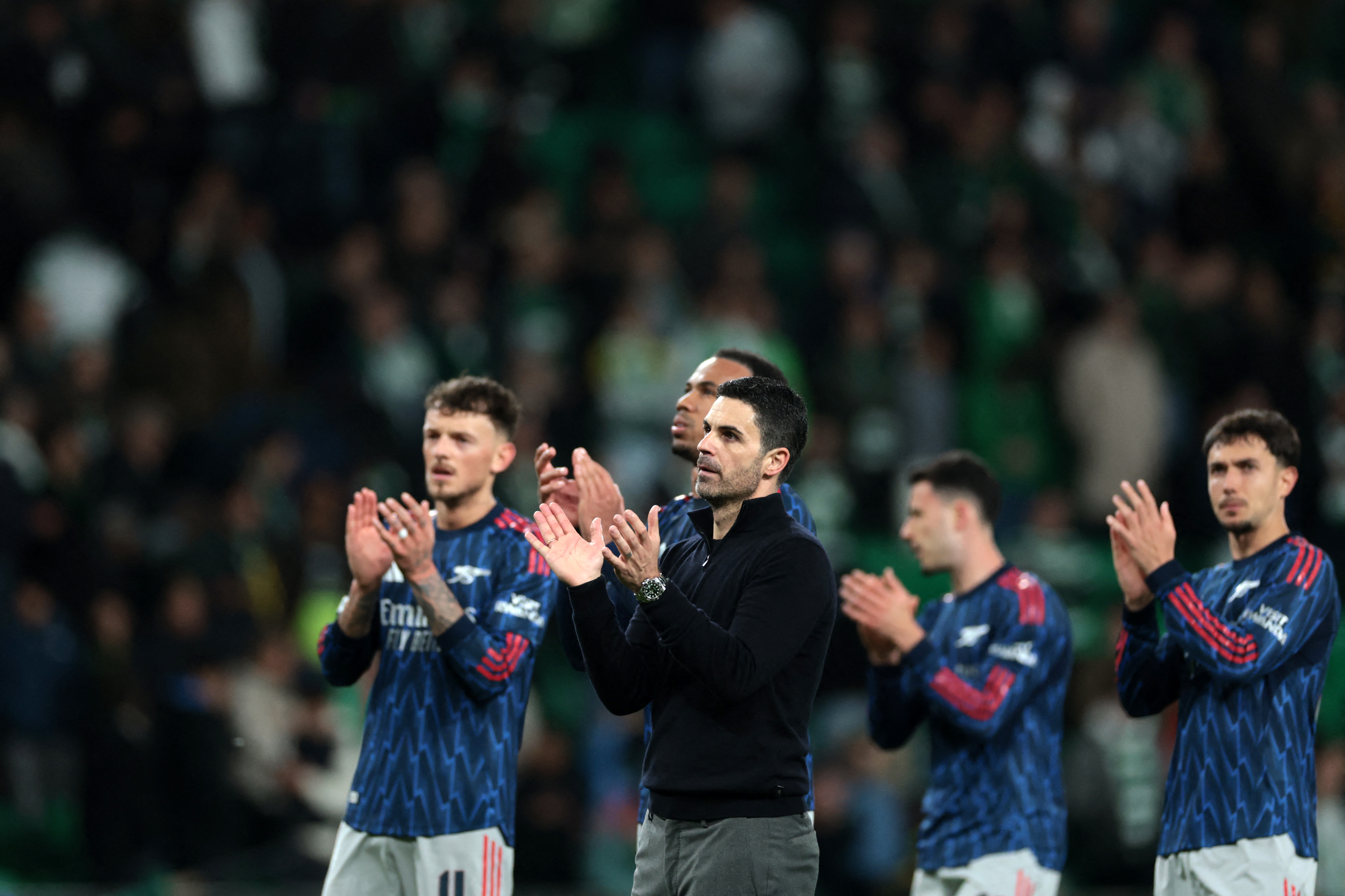 Arsenal's Spanish coach Mikel Arteta and his players acknowledge their fans after winning the UEFA Champions League quarter final first leg football match between Sporting CP and Arsenal at Jose Alvalade stadium in Lisbon on April 7, 2026. (Photo by PATRICIA DE MELO MOREIRA / AFP)