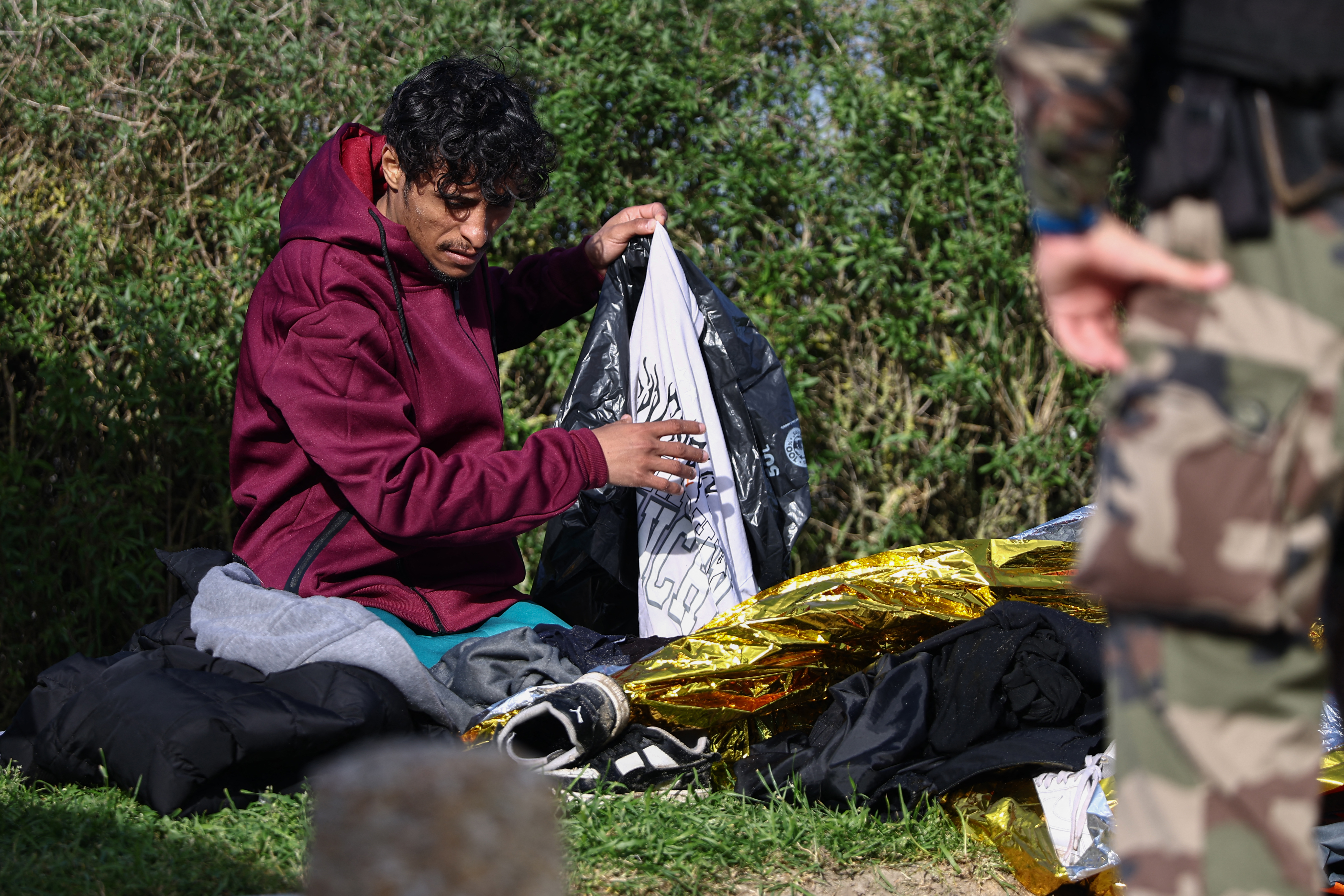 A man packs his belongings after an attempt to cross the English Channel illegally turned tragic with several migrants found in cardiac arrest