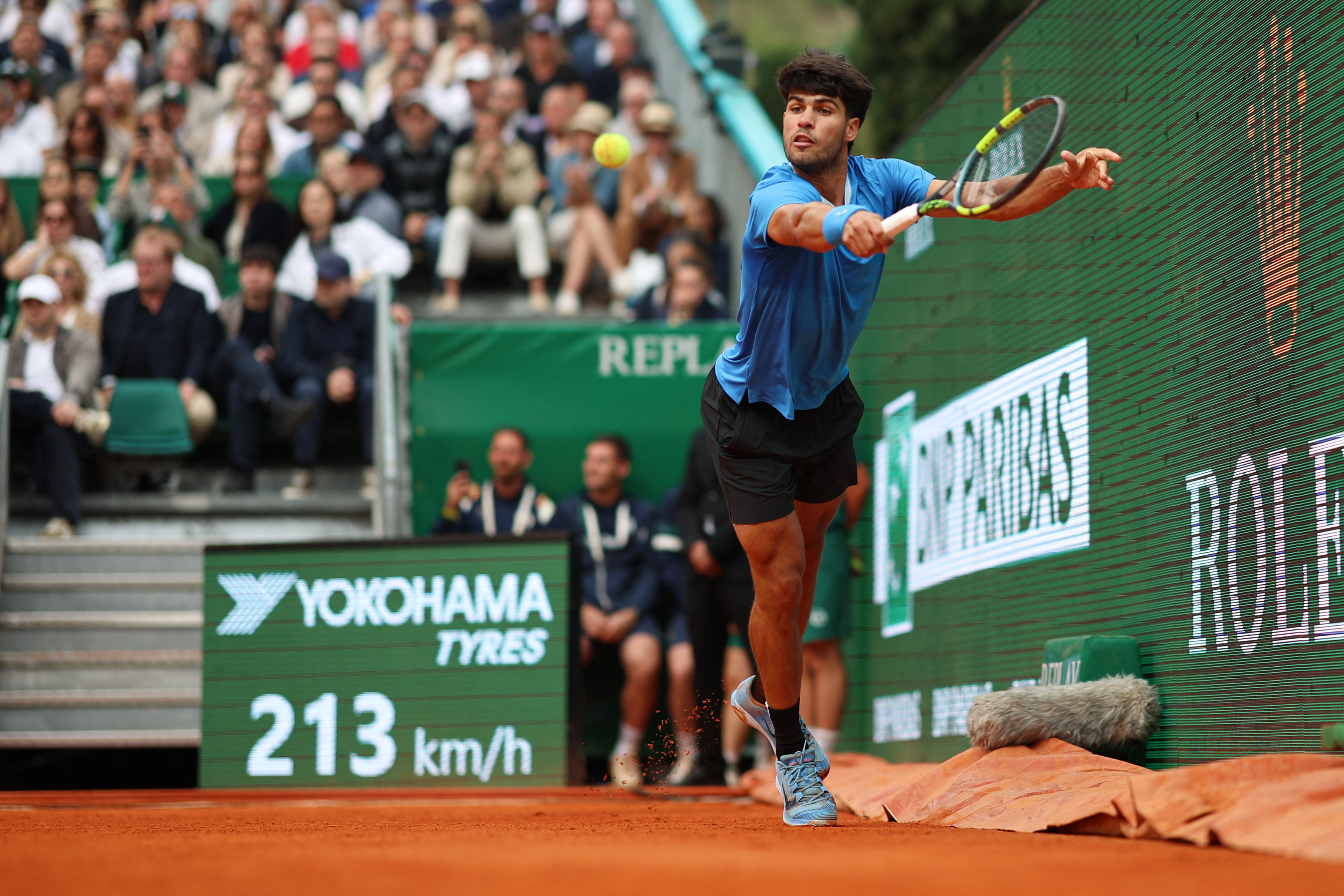 Spain's Carlos Alcaraz plays backhand return to Italy's Jannik Sinner during the Monte Carlo ATP Masters Series Tournament final tennis match on Court Rainier III at the Monte-Carlo Country Club in Roquebrune-Cap-Martin, south-eastern France on April 12, 2026. (Photo by Valery HACHE / AFP)