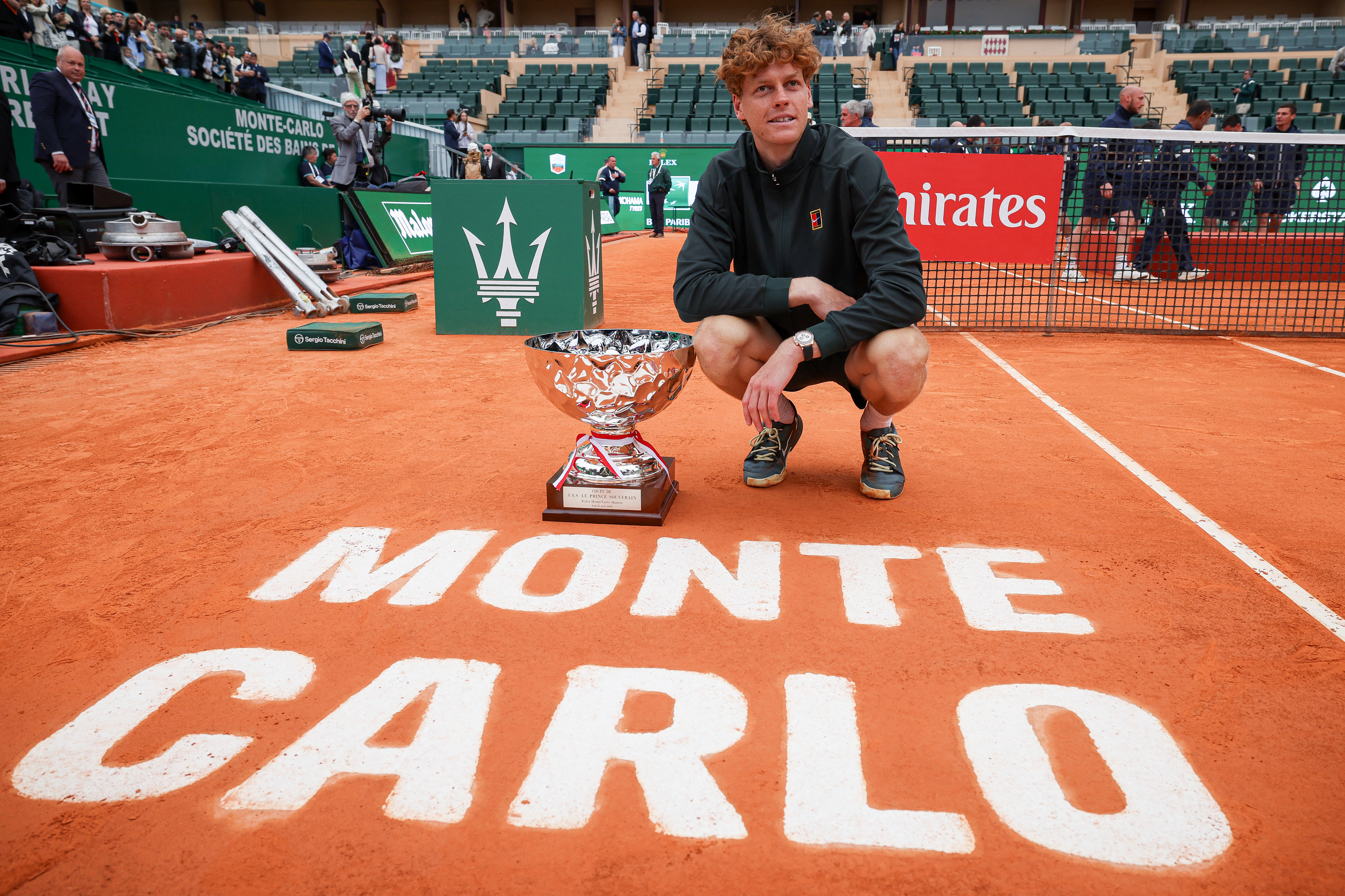Italy's Jannik Sinner poses with the trophy after winning the Monte Carlo ATP Masters Series Tournament final tennis match against Spain's Carlos Alcaraz on Court Rainier III at the Monte-Carlo Country Club in Roquebrune-Cap-Martin, south-eastern France on April 12, 2026. (Photo by Valery HACHE / AFP)