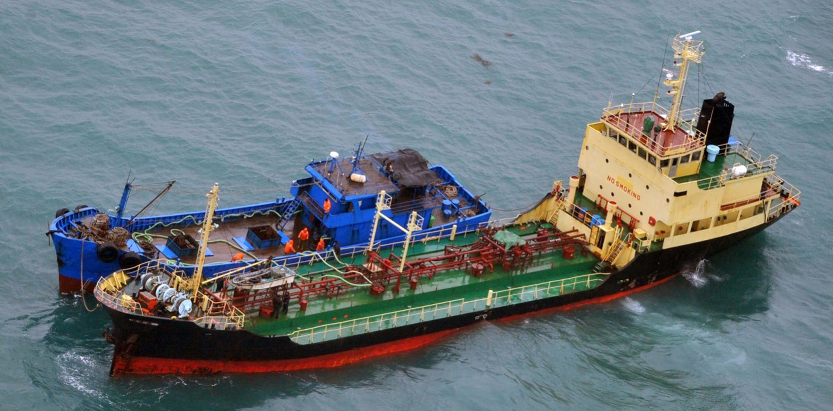 FILE - This Feb. 16, 2018, file photo released by Japan's Ministry of Defense shows what it says North Korean-flagged tanker Yu Jong 2, bottom, and Min Ning De You 078 lying alongside in the East China Sea. Diplomats say Russia has asked for additional time to investigate U.S. allegations that North Korea is smuggling refined petroleum products into the country beyond the quota of 500,000 barrels per year allowed under U.N. sanctions. (Japan's Ministry of Defense via AP, File)