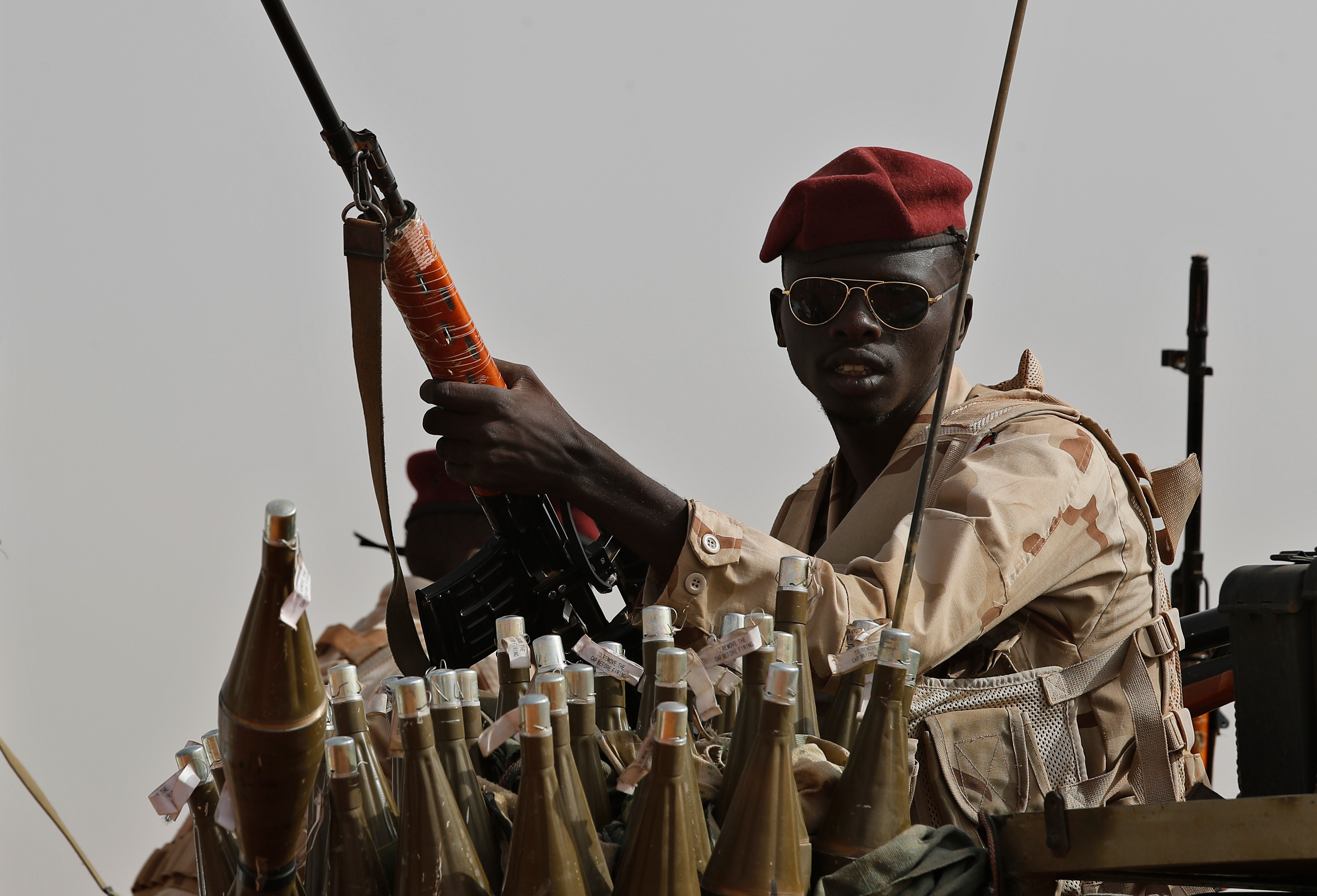 Sudanese soldiers from the Rapid Support Forces unit, led by Gen. Mohammed Hamdan Dagalo, the deputy head of the military council, secure the area where Dagalo attends a military-backed tribe's rally, in the East Nile province, Sudan, on June 22, 2019. [Hussein Malla/AP Photo]