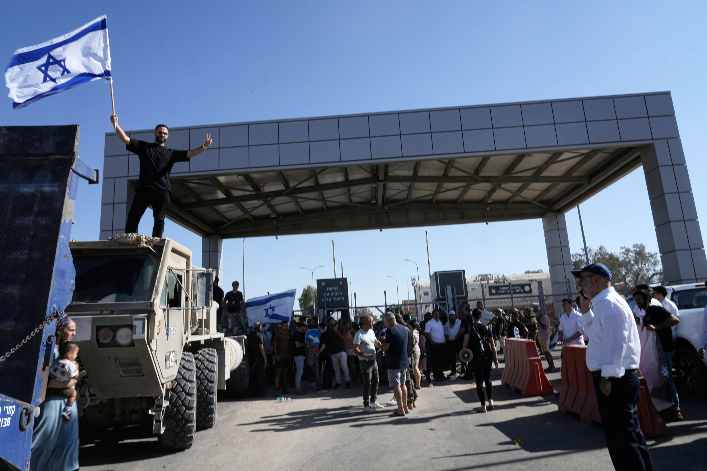A protester waves the Israeli flag in support of the soldiers accused of abuse, outside the Sde Teiman detention centre in July 2024
