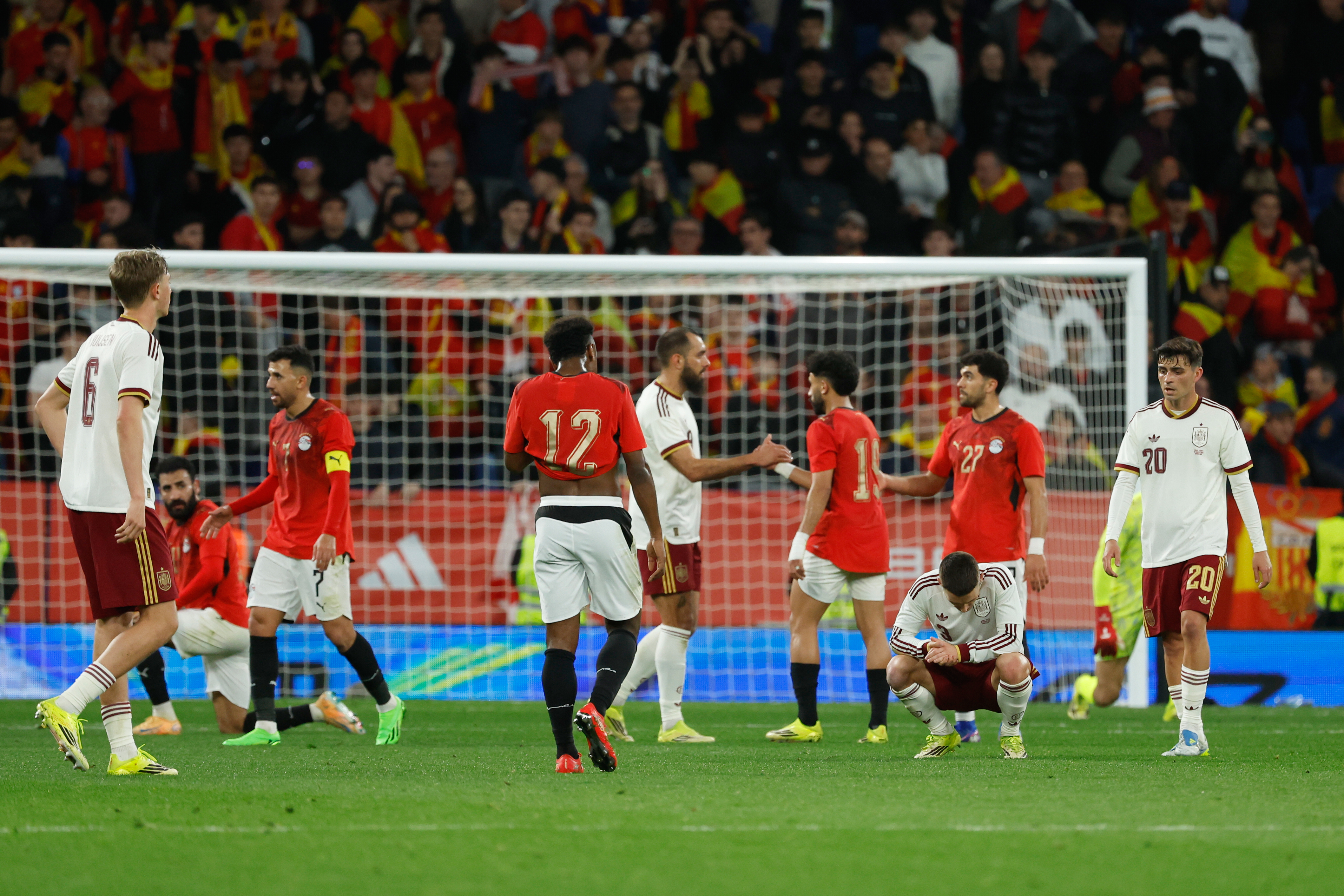 Spain's and Egypt players react at the end of the international friendly soccer match between Spain and Egypt in Barcelona