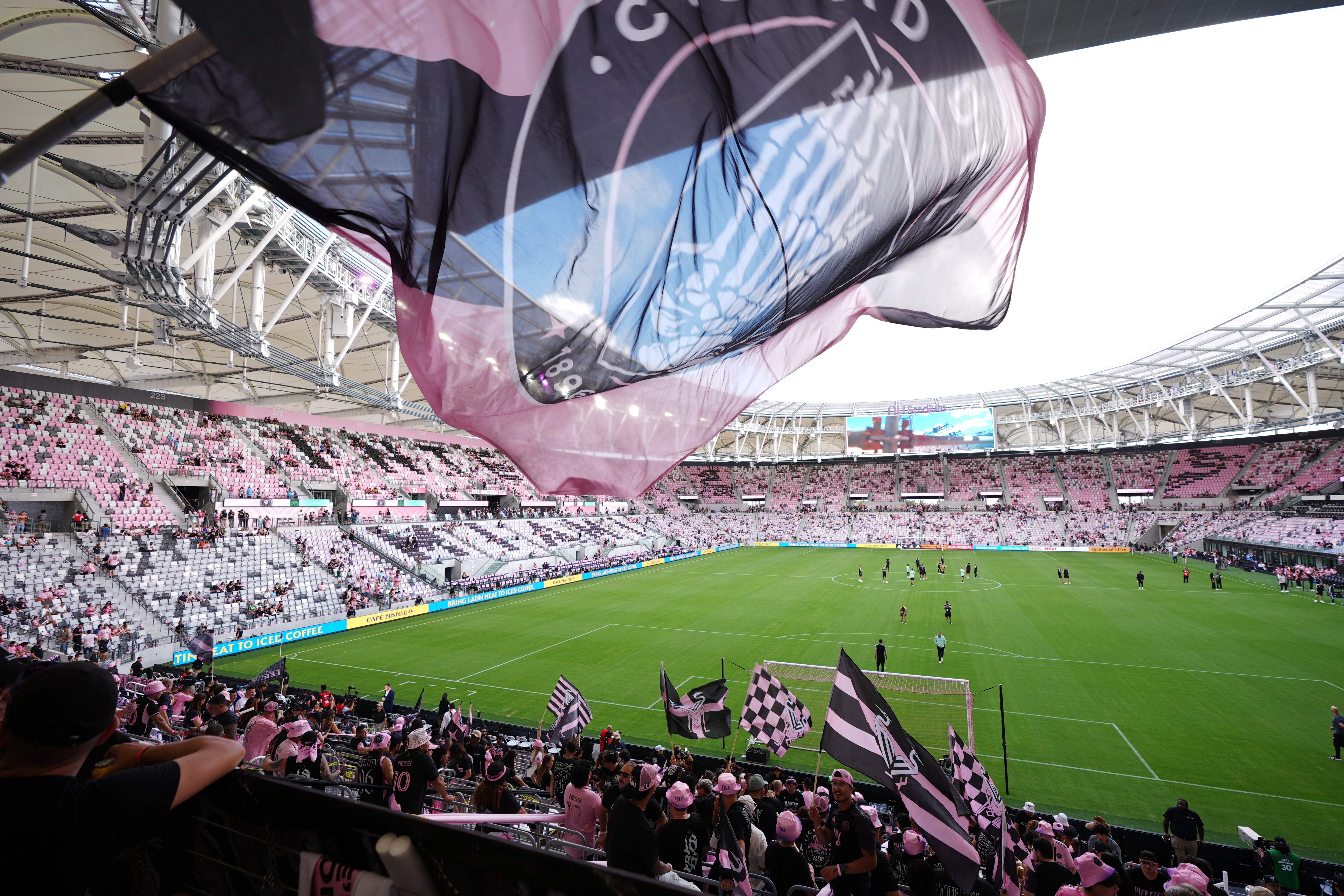 Inter Miami fans wave flags in Nu Stadium ahead of the team's first MLS soccer match in their new home stadium, against Austin FC, Saturday, April 4, 2026, in Miami. (AP Photo/Rebecca Blackwell)