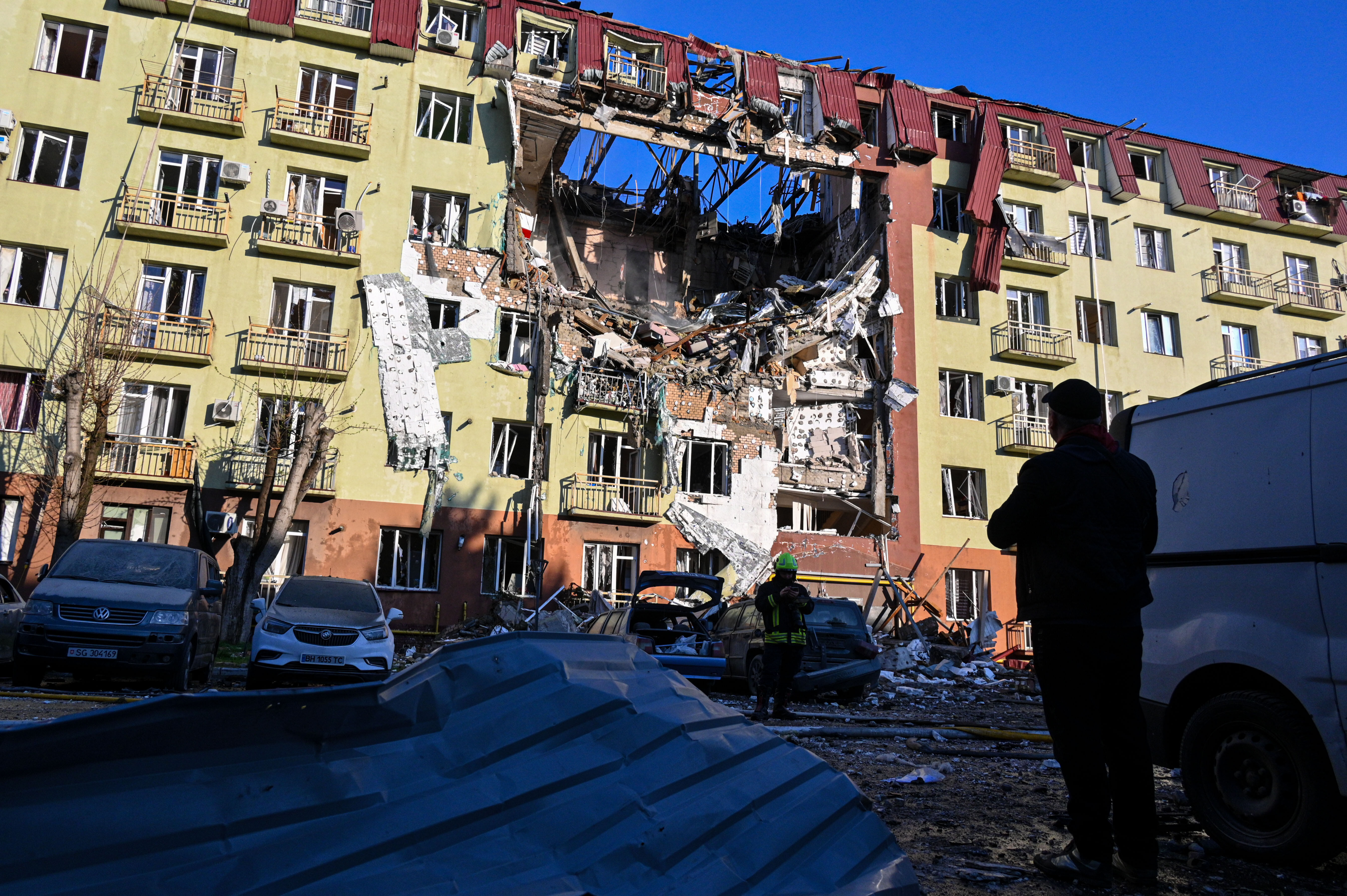 A rescue worker walks in front of a residential building, which was heavily damaged after a Russian strike in Odesa, Ukraine on April 6, 2026.