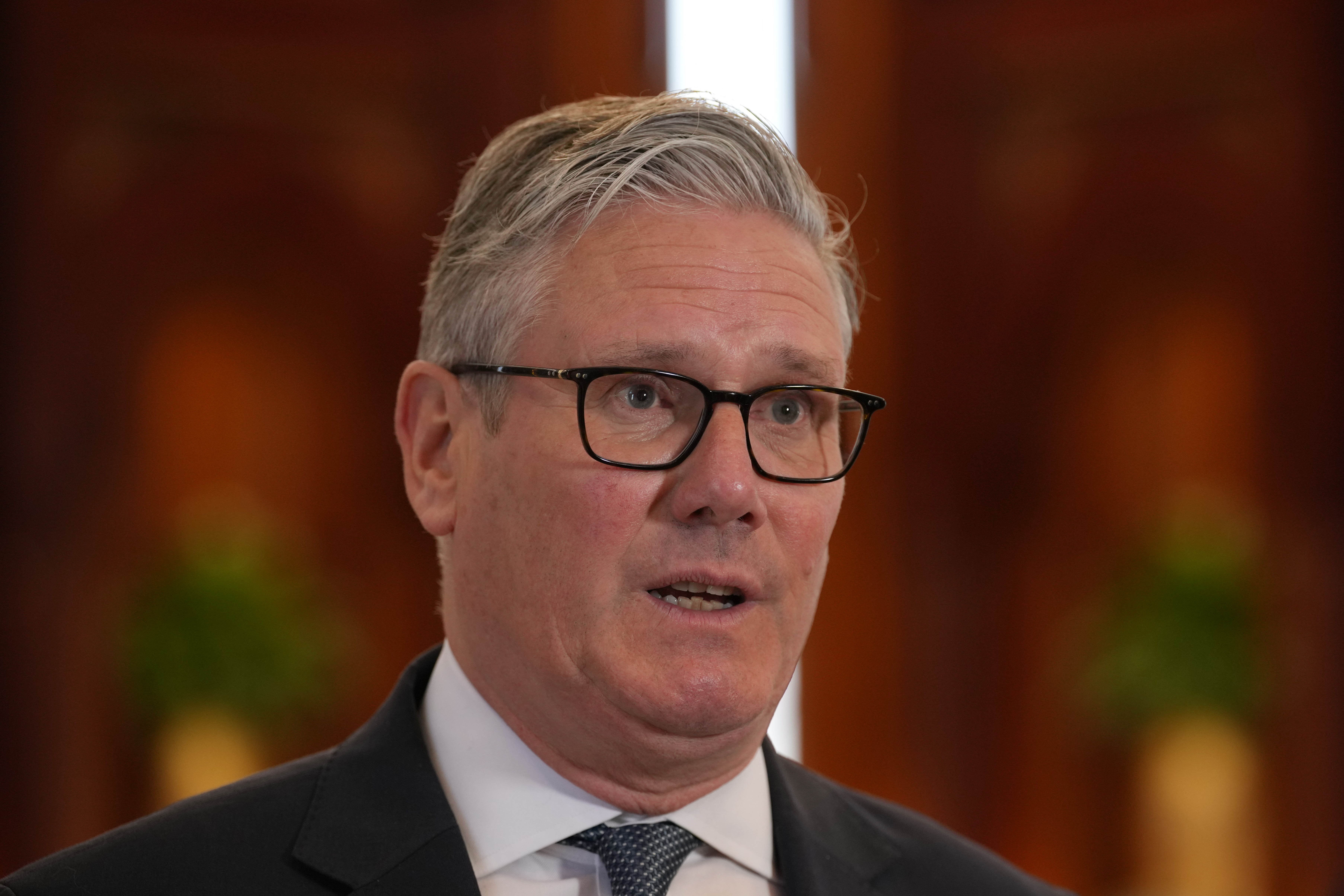 Britain's Prime Minister Keir Starmer speaks to the media at the airport in Doha, Qatar on April 10, 2026.