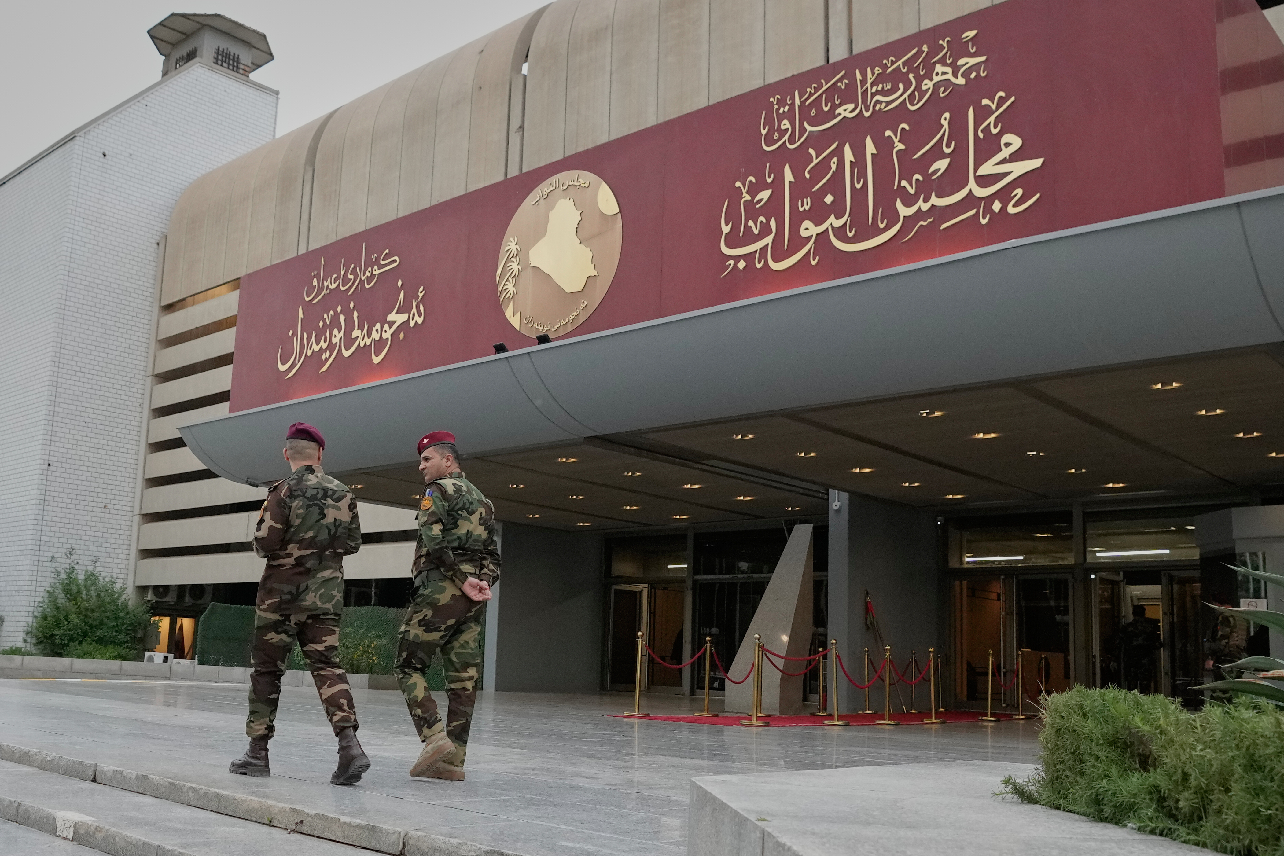 Guards stand outside a building.