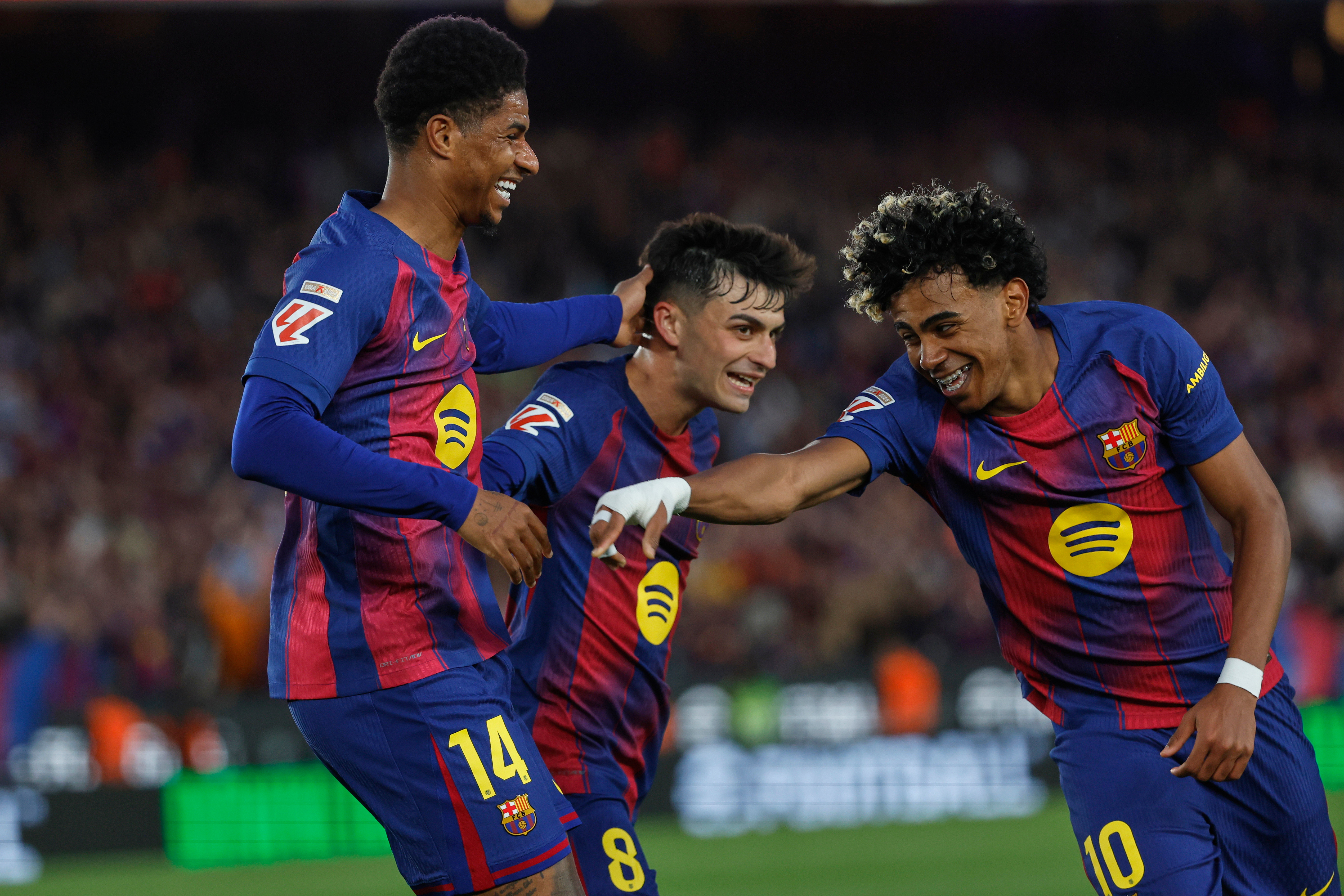 Barcelona's Lamine Yamal, right, celebrates scoring in the Champions League