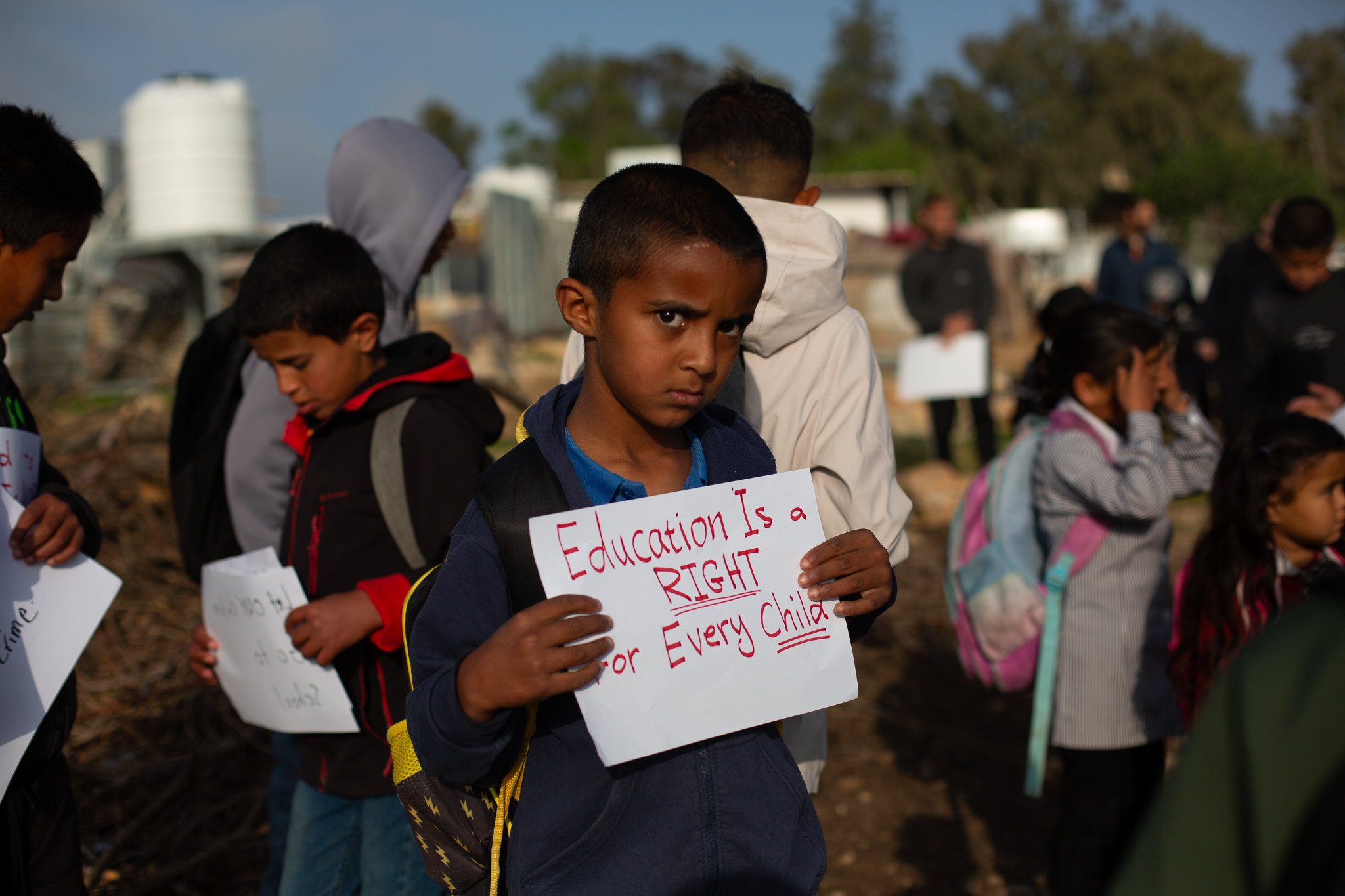Boy in UAK holding sign [Jacob Lazarus/Al Jazeera] 