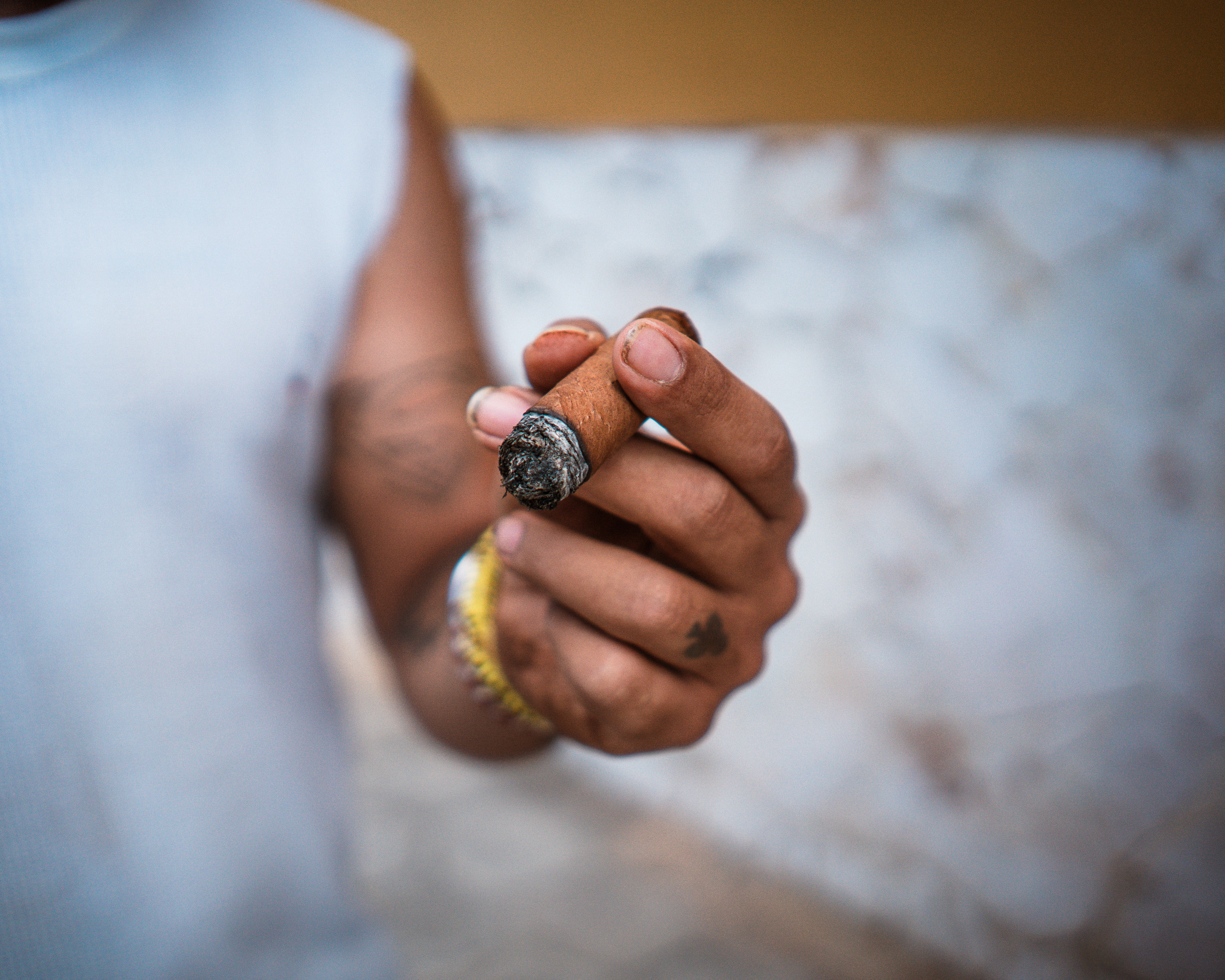A man smokes a cigar outside Havana’s La Corona cigar factory.