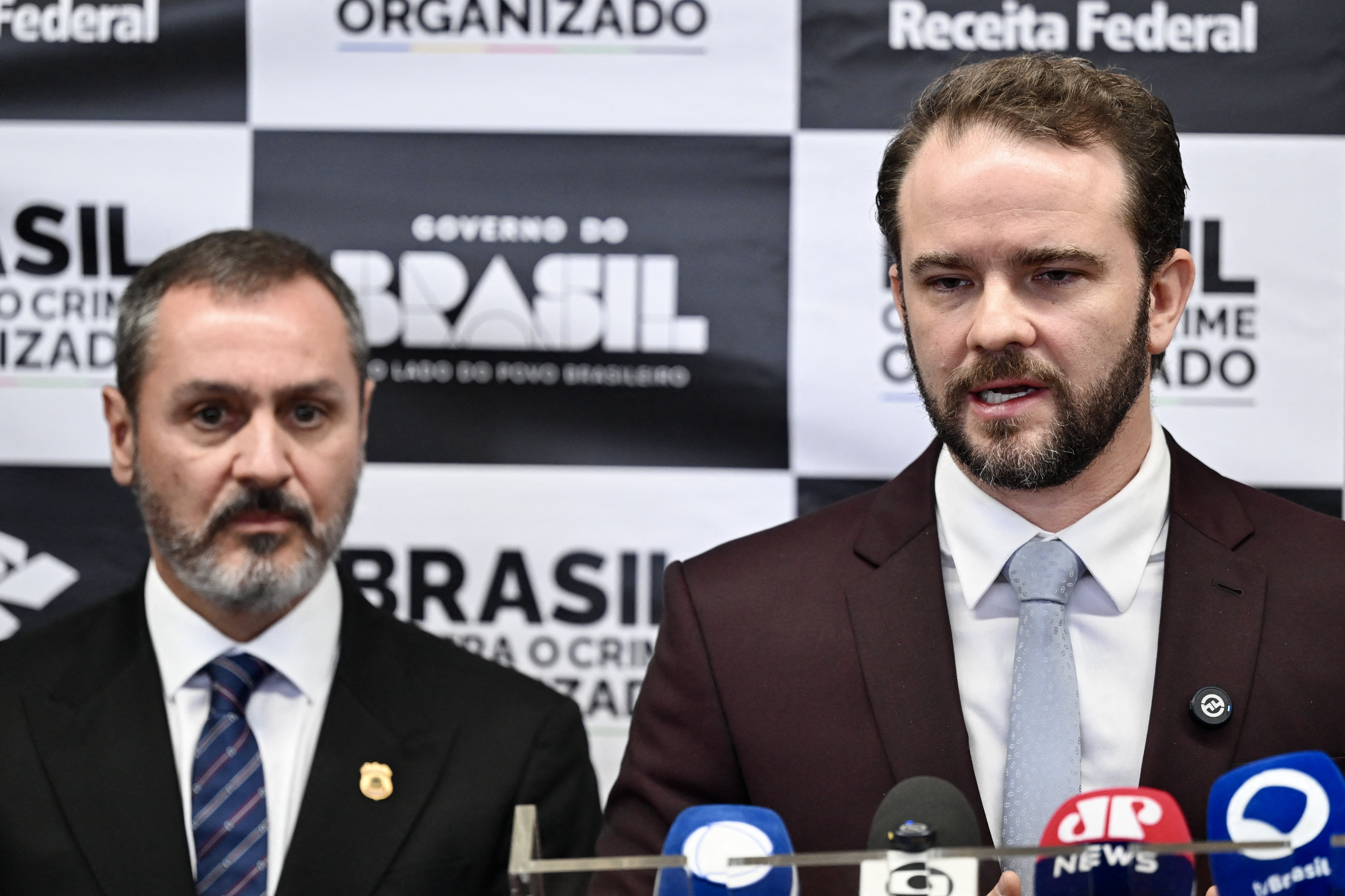 Brazil’s Finance Minister Dario Durigan (R) speaks next to the Brazilian Federal Police director-general Andrei Rodrigues during the announcement of a cooperation agreement between the Brazilian Federal Revenue Service (RFB) and US Customs and Border Protection (CBP) to combat transnational crime, in Brasília, Brazil, on April 10. 2026.